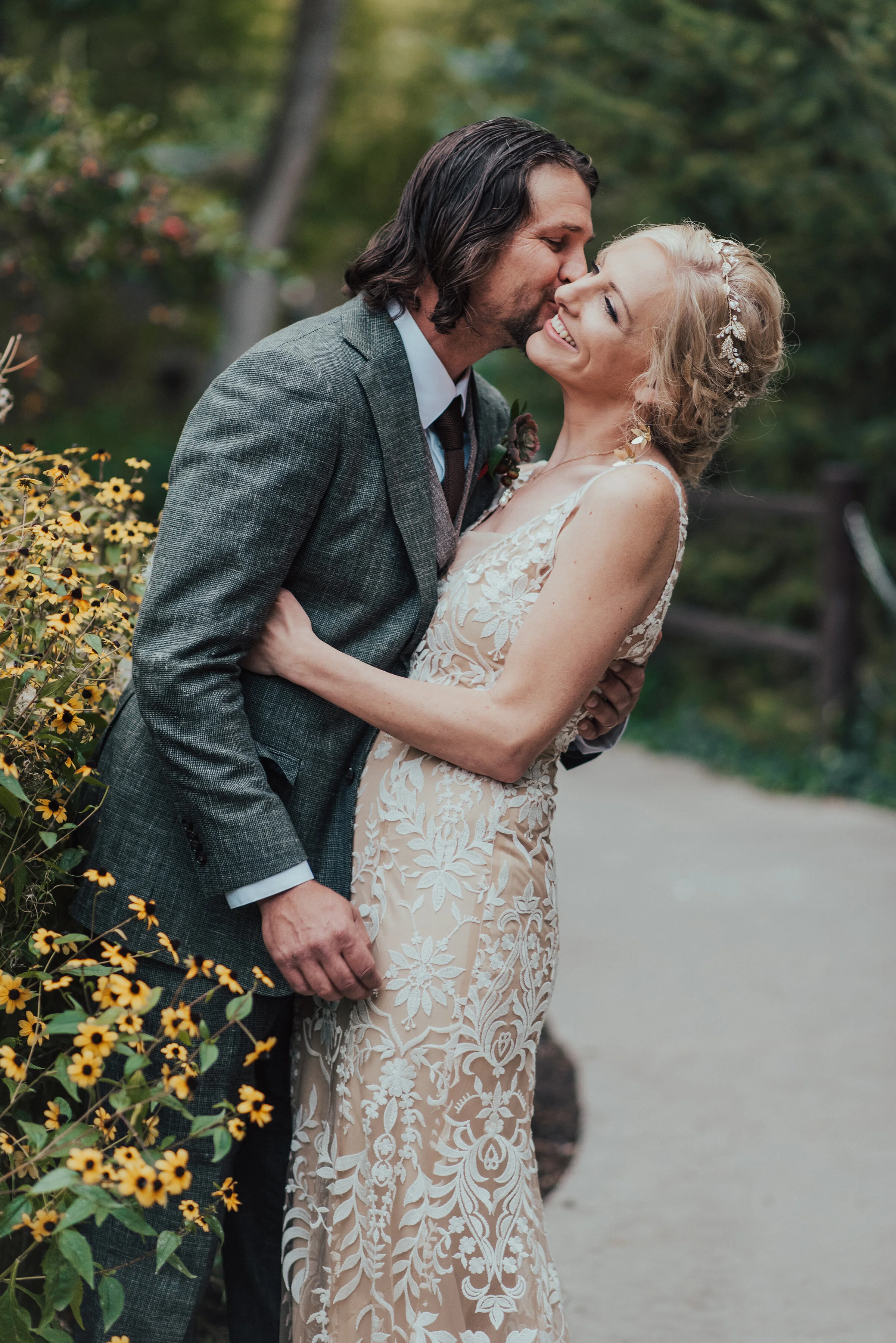  Happy couple at a boho wedding with a lace wedding dress and a dark gray suit by Kristi Alyse Photography in Northern Utah. salt lake city wedding photographer how to dress for boho wedding how to dress groom for boho wedding bridal dress ideas for 