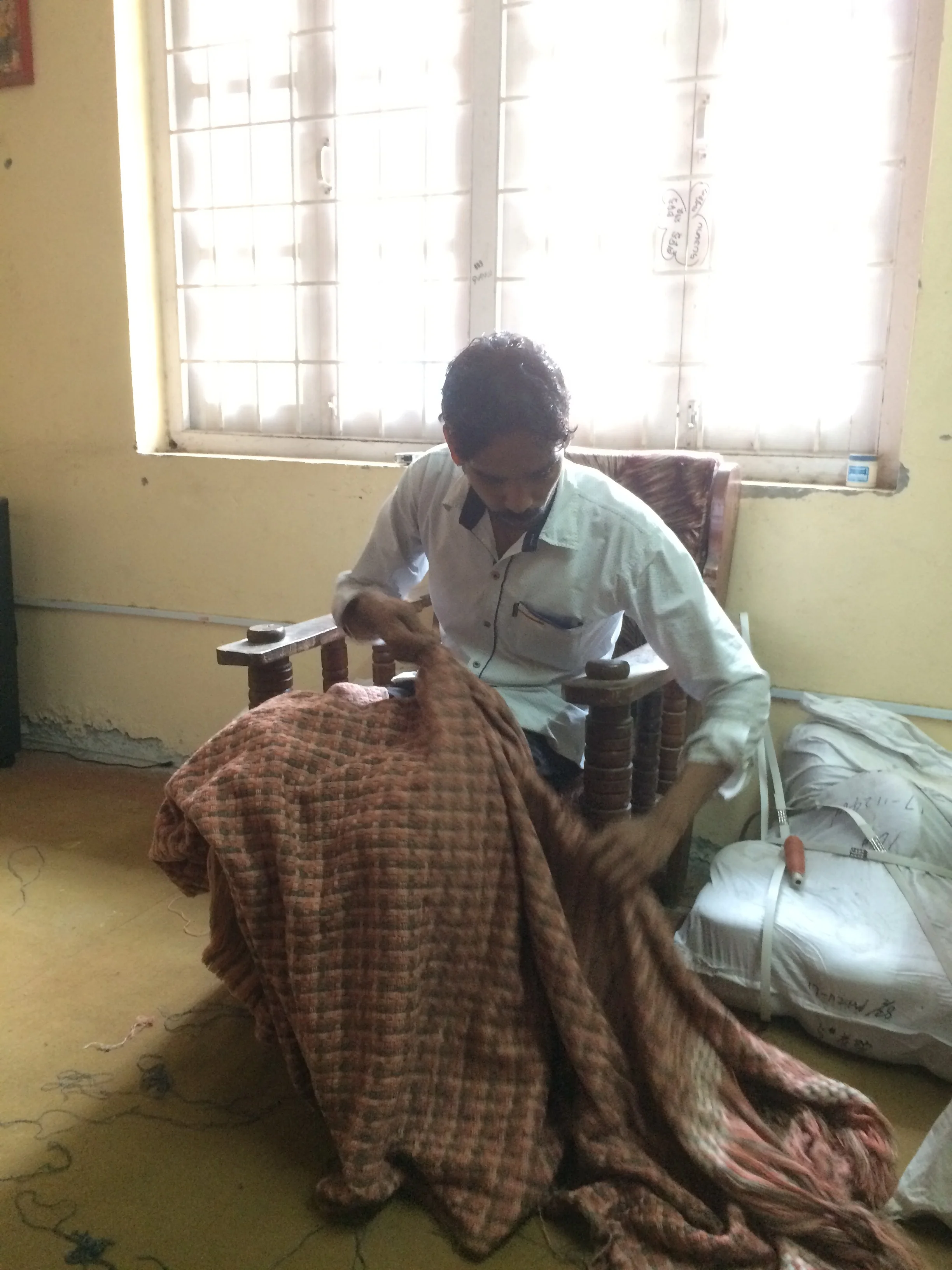 A freshly woven Chaperone throw is inspected right after it has come off the loom