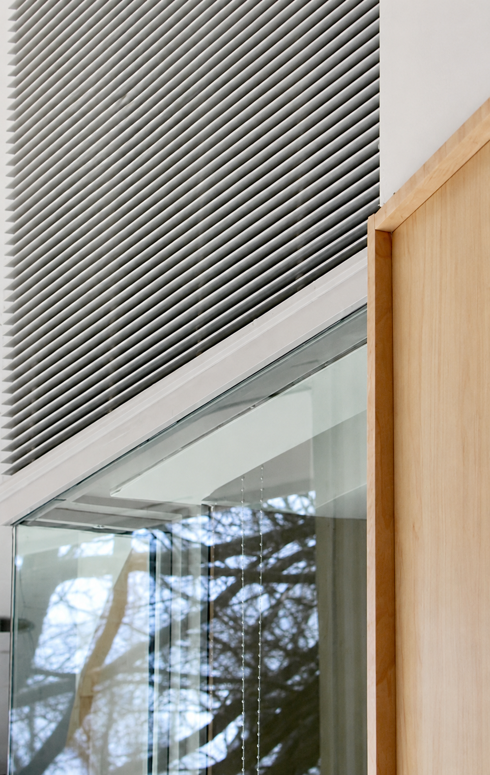 Detail at glass, custom louver, and wood.png