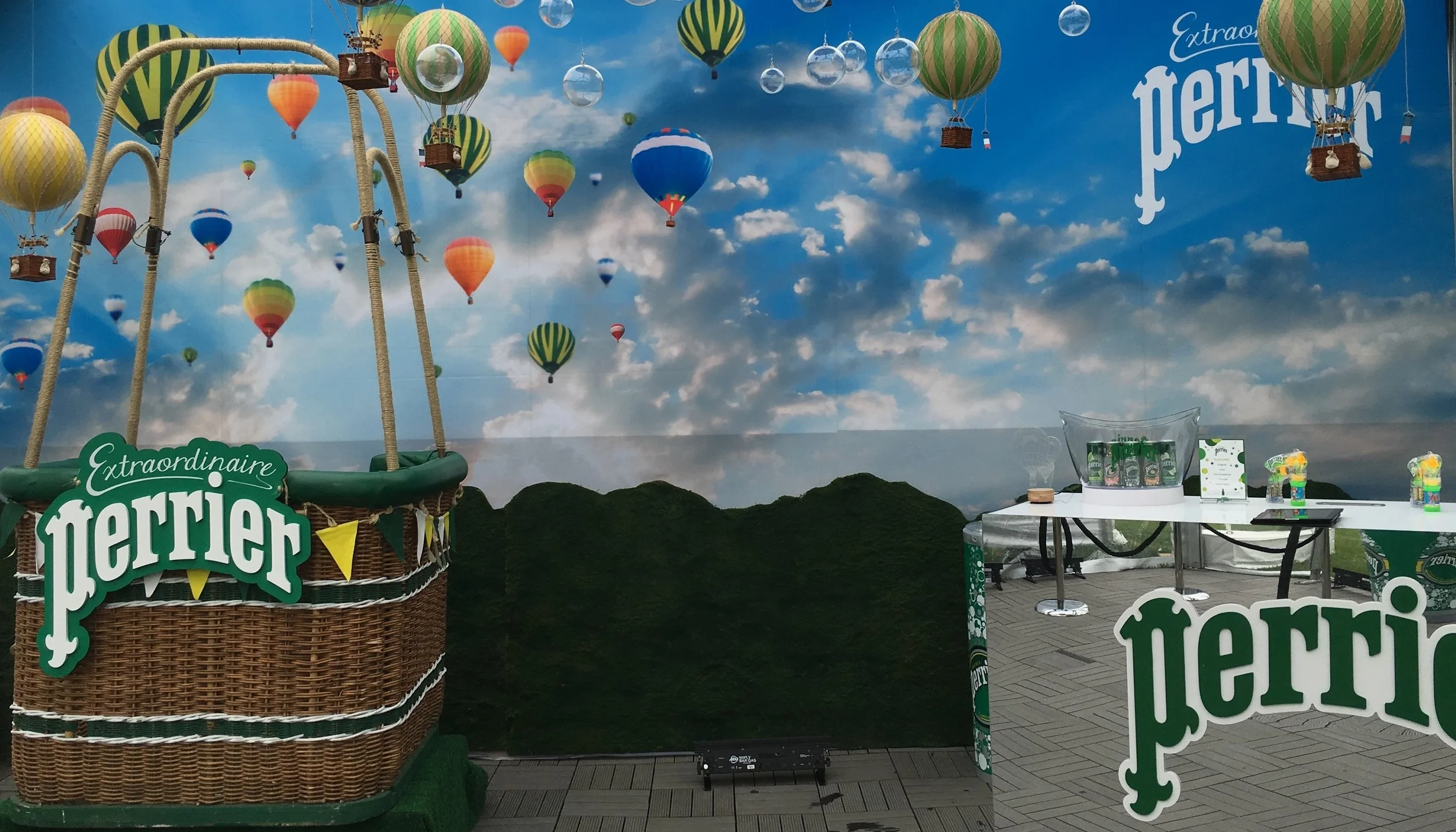 Bubbles and miniature hot air balloons fill the skies above the moss mountain backdrop, photo op and sampling station.&nbsp;
