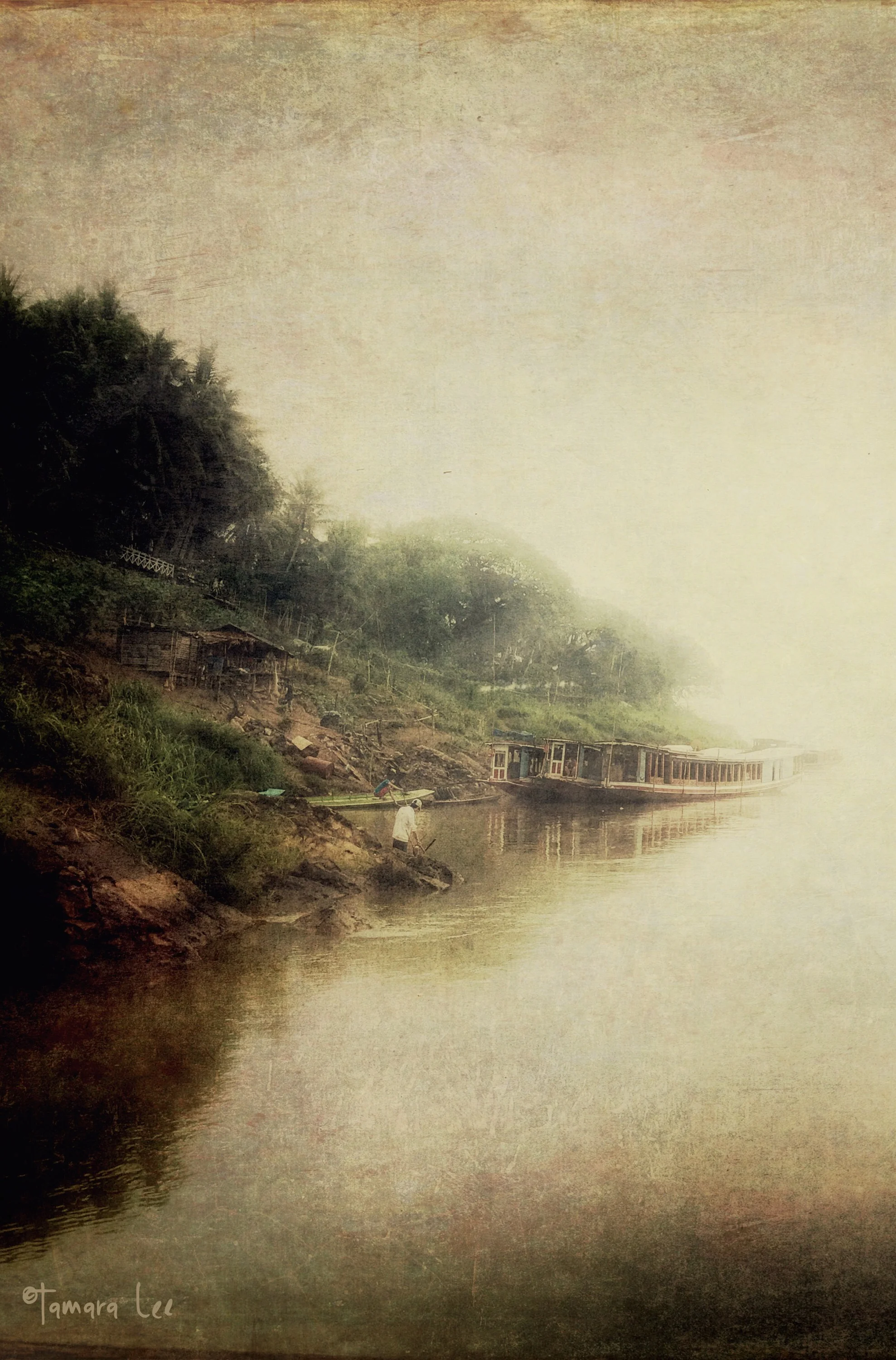 Fishing along the foggy shores of the Mekong River