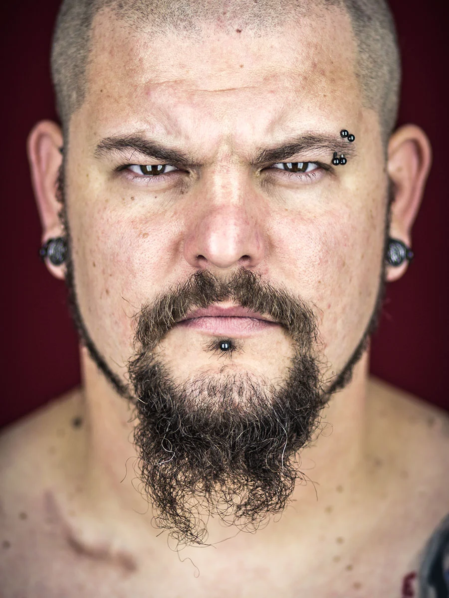 This series of Raw Portraits (Mugs) was created to show the raw beauty of humans. As people were coming in for headshots, I asked them to sit in front of the camera without having any makeup applied, without their hair being done. Then with simple post processing the texture was brought out and skin was slightly desaturated.