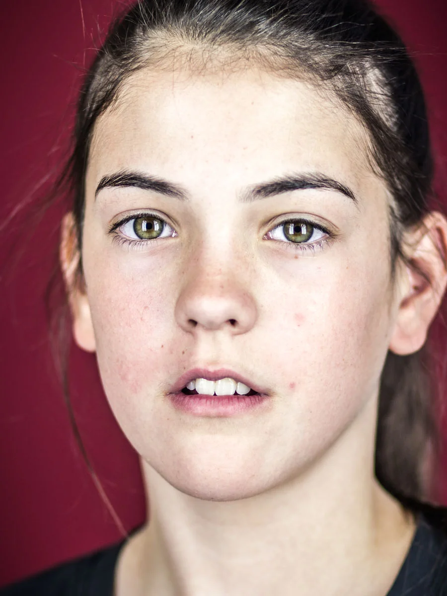 This series of Raw Portraits (Mugs) was created to show the raw beauty of humans. As people were coming in for headshots, I asked them to sit in front of the camera without having any makeup applied, without their hair being done. Then with simple post processing the texture was brought out and skin was slightly desaturated.