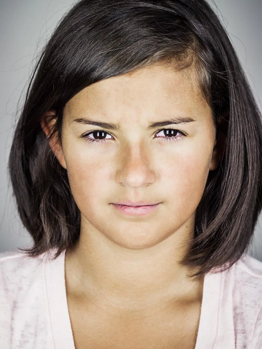 This series of Raw Portraits (Mugs) was created to show the raw beauty of humans. As people were coming in for headshots, I asked them to sit in front of the camera without having any makeup applied, without their hair being done. Then with simple post processing the texture was brought out and skin was slightly desaturated.
