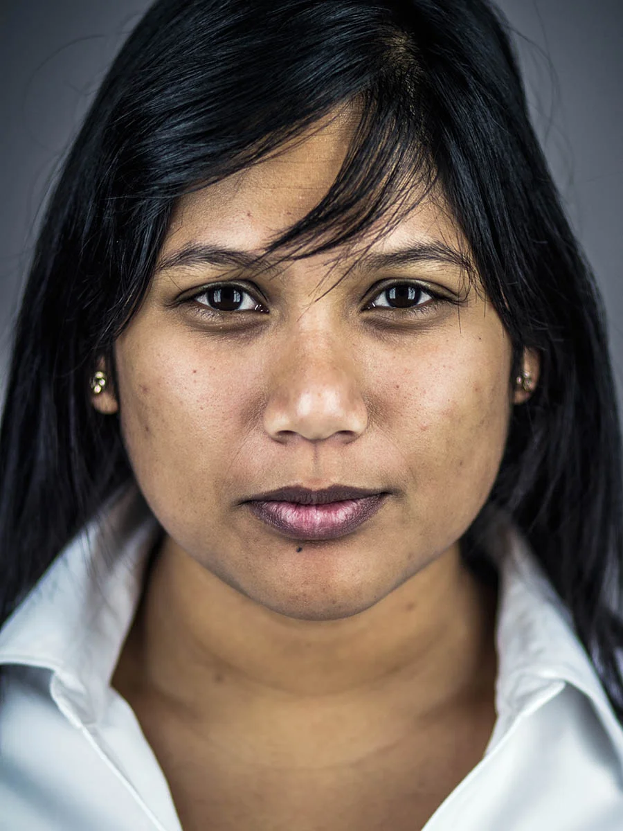 This series of Raw Portraits (Mugs) was created to show the raw beauty of humans. As people were coming in for headshots, I asked them to sit in front of the camera without having any makeup applied, without their hair being done. Then with simple post processing the texture was brought out and skin was slightly desaturated.