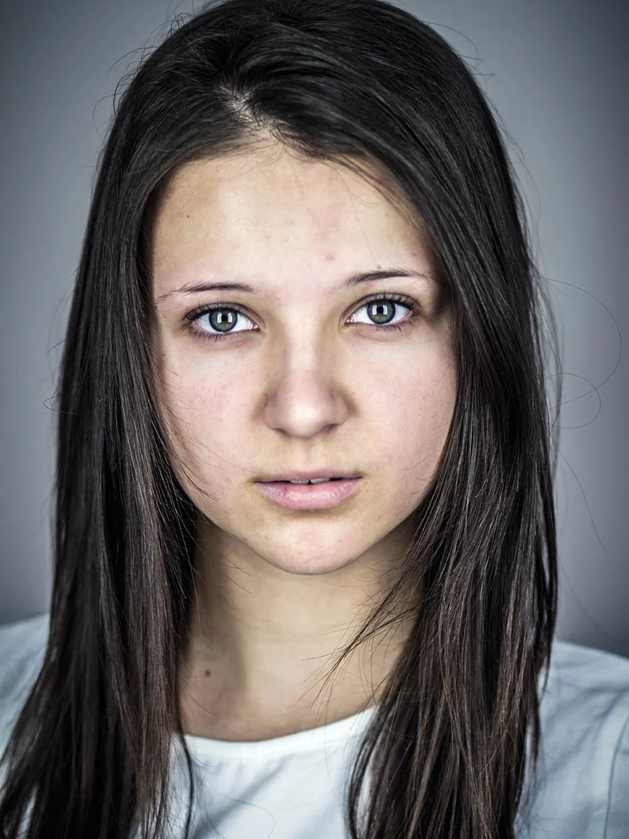 This series of Raw Portraits (Mugs) was created to show the raw beauty of humans. As people were coming in for headshots, I asked them to sit in front of the camera without having any makeup applied, without their hair being done. Then with simple post processing the texture was brought out and skin was slightly desaturated.