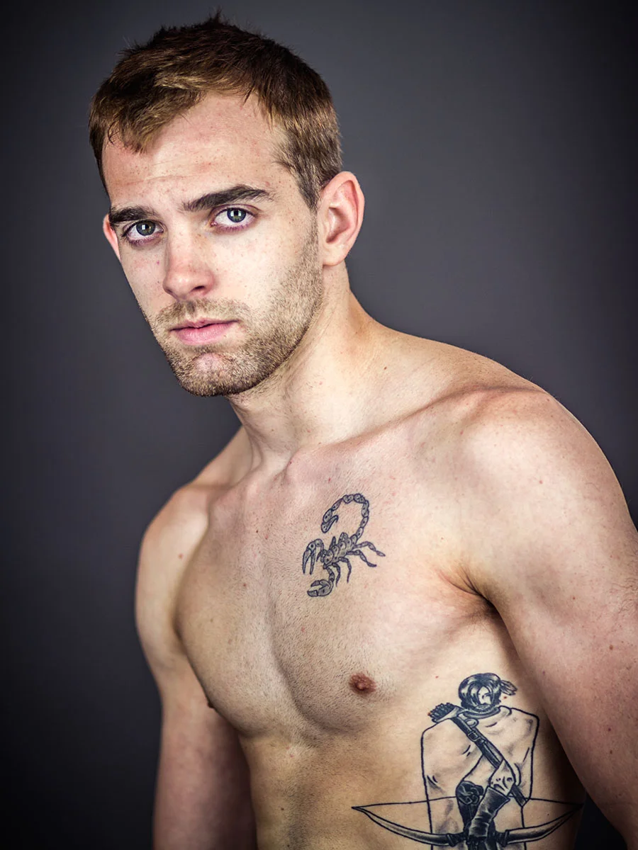 This series of Raw Portraits (Mugs) was created to show the raw beauty of humans. As people were coming in for headshots, I asked them to sit in front of the camera without having any makeup applied, without their hair being done. Then with simple post processing the texture was brought out and skin was slightly desaturated.