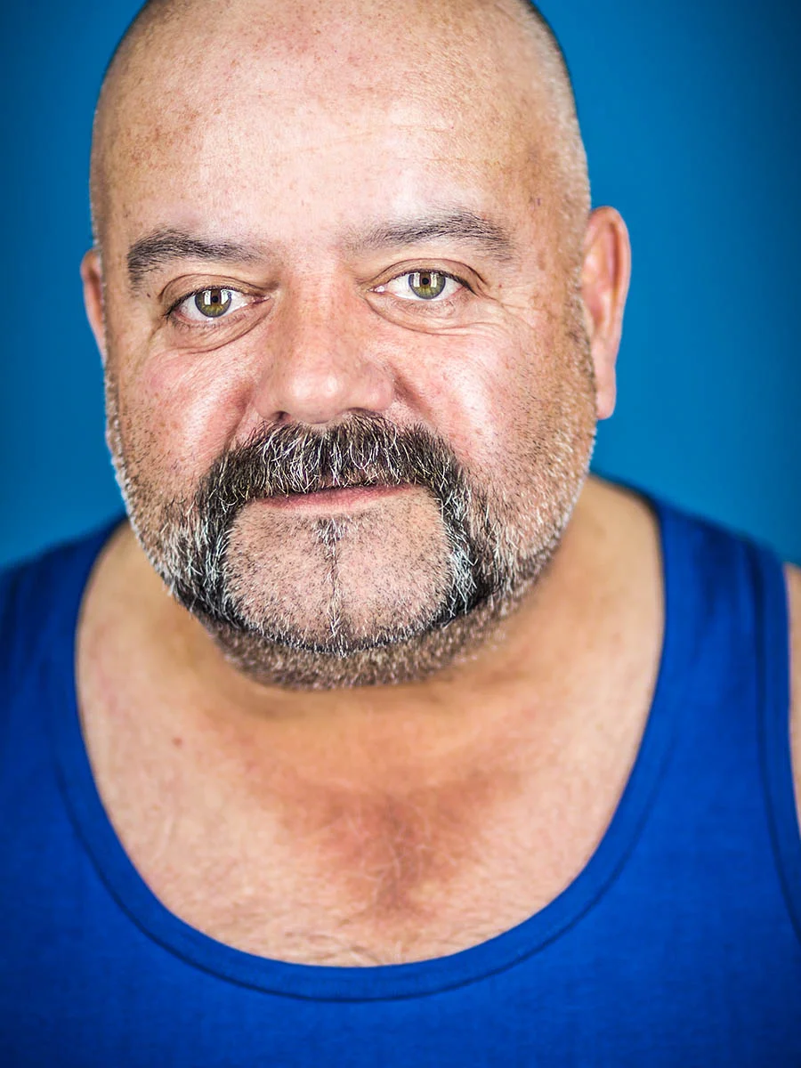This series of Raw Portraits (Mugs) was created to show the raw beauty of humans. As people were coming in for headshots, I asked them to sit in front of the camera without having any makeup applied, without their hair being done. Then with simple post processing the texture was brought out and skin was slightly desaturated.