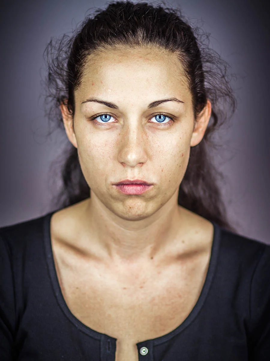 This series of Raw Portraits (Mugs) was created to show the raw beauty of humans. As people were coming in for headshots, I asked them to sit in front of the camera without having any makeup applied, without their hair being done. Then with simple post processing the texture was brought out and skin was slightly desaturated.