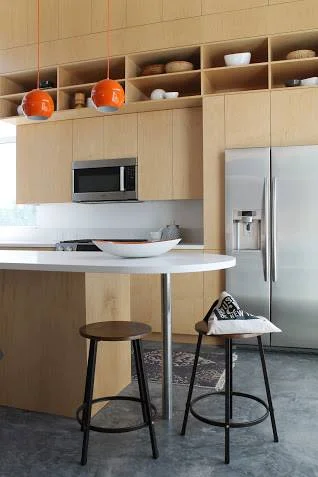 We had fun styling the upper shelves in the kitchen, simply adding modern pottery, cookbooks and baskets.