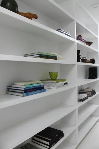The architect-owner had built two long banks of bookshelves in the skylight-lit hallway. We used considerable restraint in styling them for maximum impact.