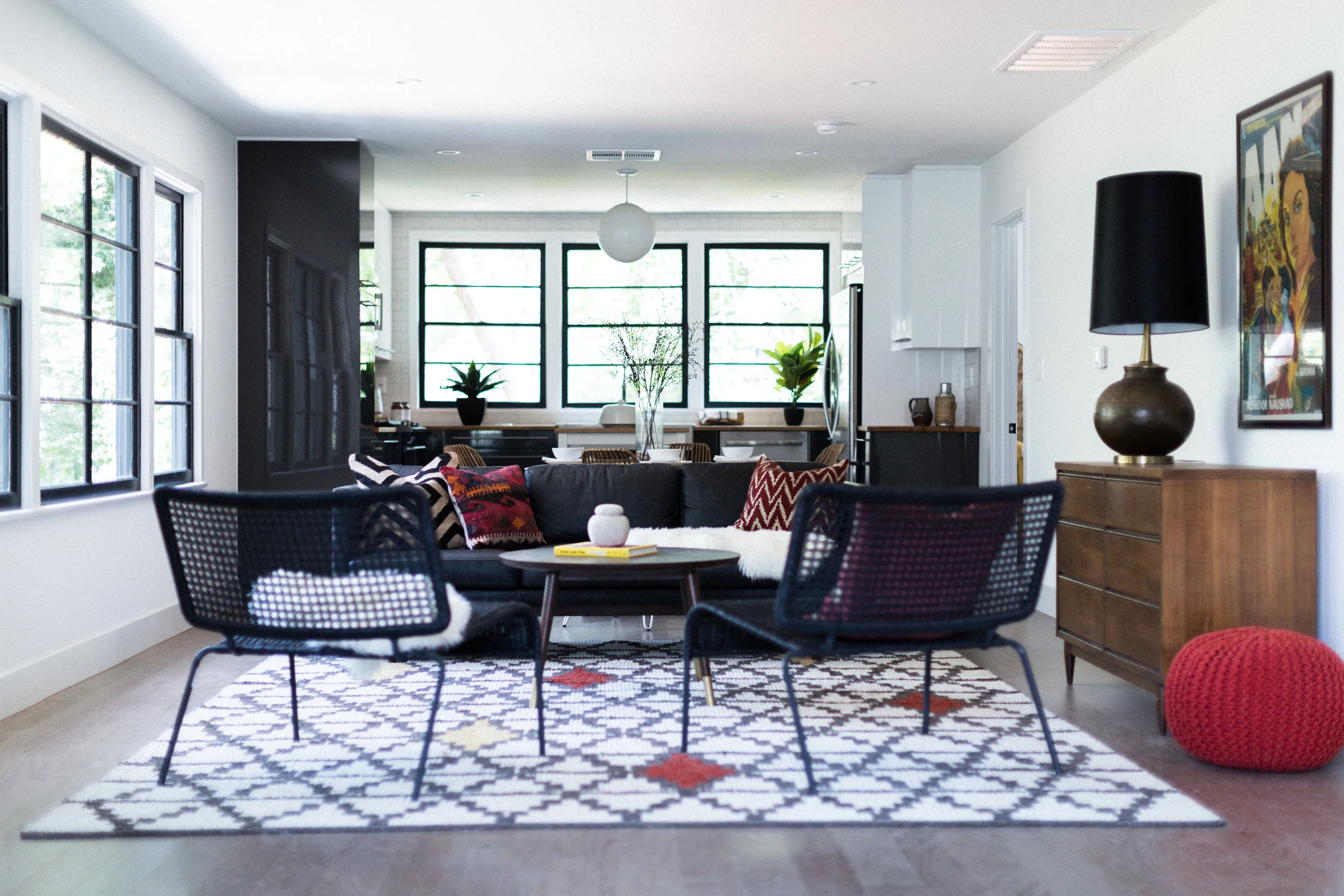 West Elm's Layla rug was our first purchase -- and the room's color inspiration. Its Moroccan tile pattern and random red-orange accents gave us permission to go bold with CB2's bright pouf - and some richly toned kilim pillows from Etsy.