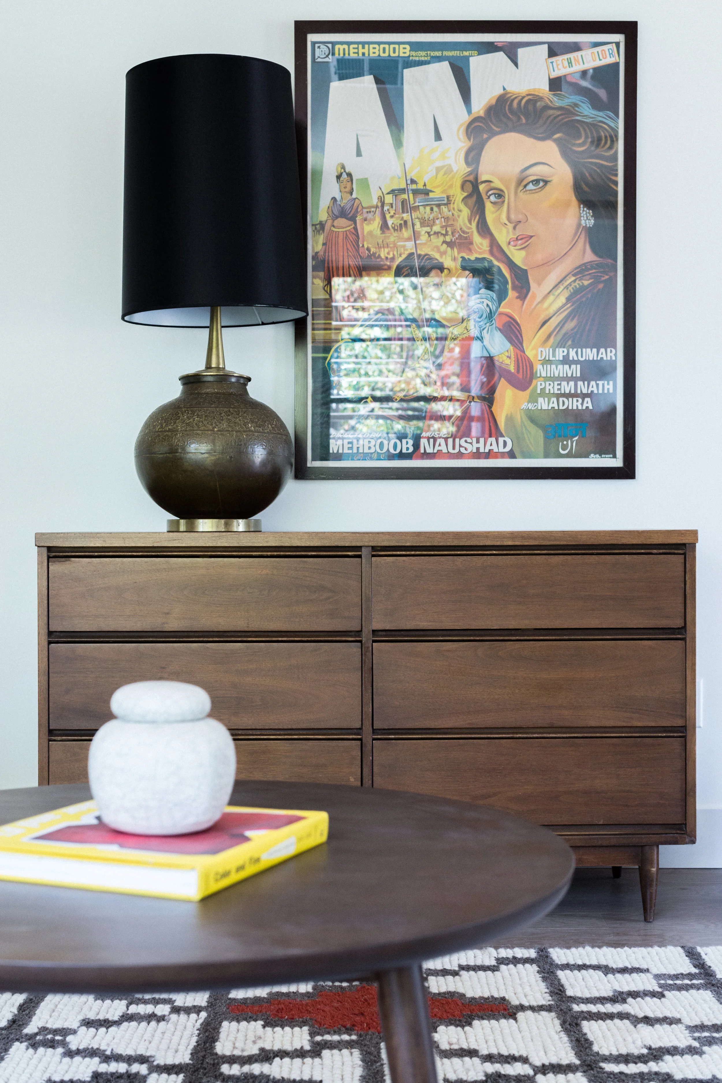 When you just happen to have an awesome vintage Bollywood poster, you just have to use it. Especially when it picks up on your colors. Below it, a vintage dresser (from craigslist, people!) we're using as a credenza, with a vintage brass lamp (thrifted!) and oversized black shade for drama.