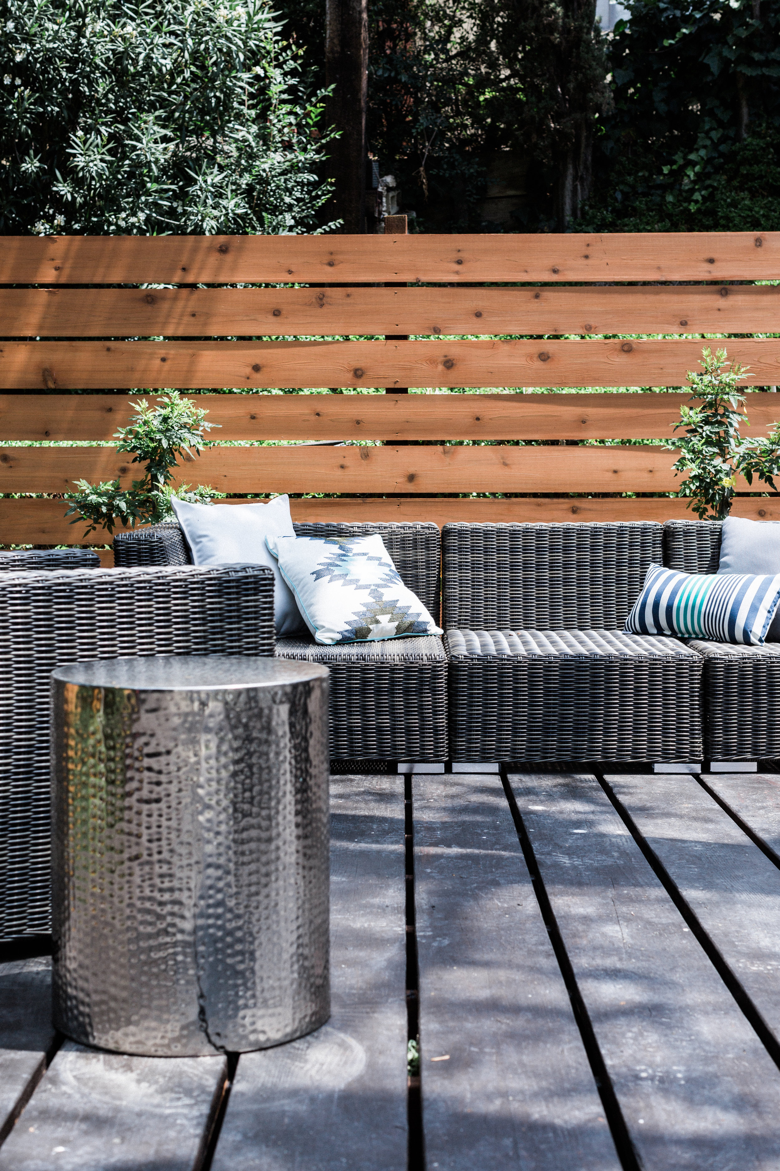 The awesome backyard deck is made even more welcoming with a sectional sofa.