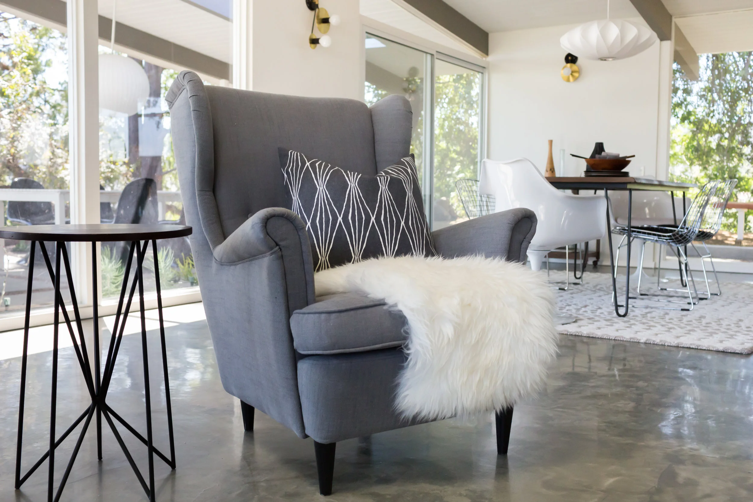 We love how IKEA's Strandmon chair looks right at home here. The pillow's geo pattern echos the side table legs.