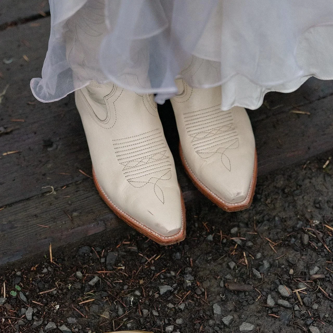  Bride wearing white cowboy boots in her linyage silk skirt for San Francisco elopement. 