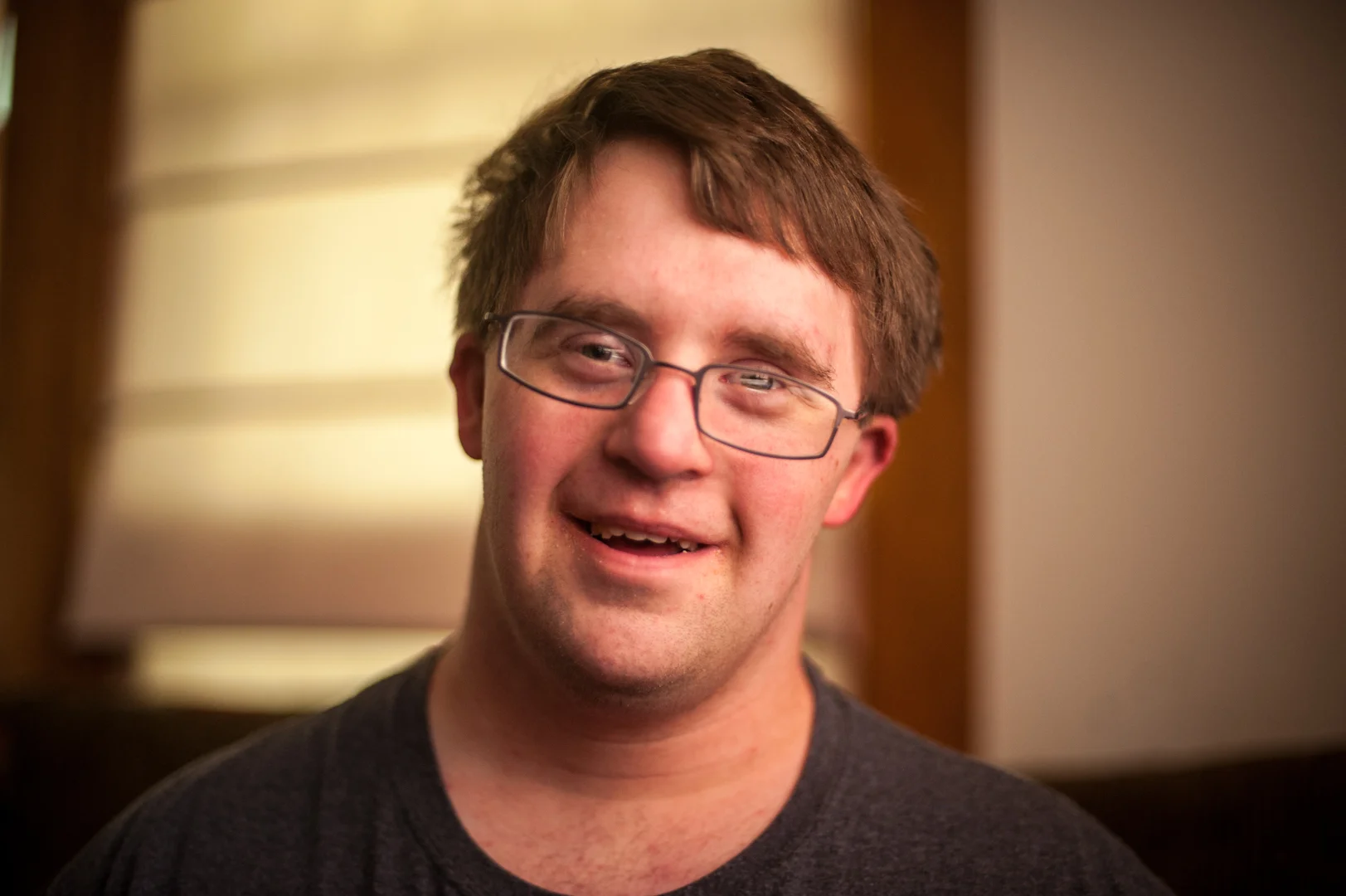  Sean Smith is a 25-year-old man from Omaha who was born with Down Syndrome. His behavioral issues presented challenges early on in life. As his father recalls, Sean was "kicked out" of several child care centers when the providers found it difficult