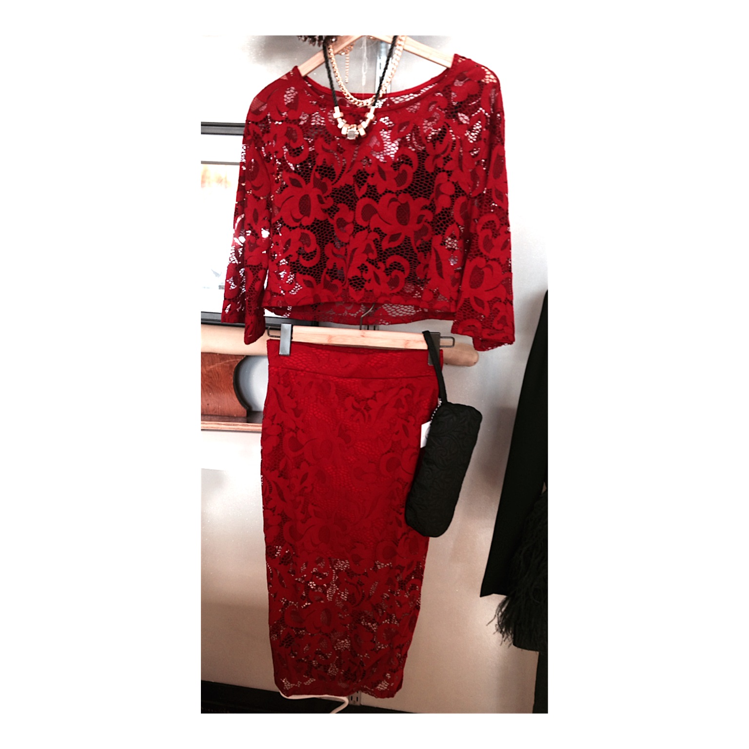 two piece holiday outfit featuring a sheer top with a black lace bralette underneath, and a matching skirt. this look is also paired with a hardwear necklace and a locally made clutch by a+m. perfect for a holiday or new year's look!