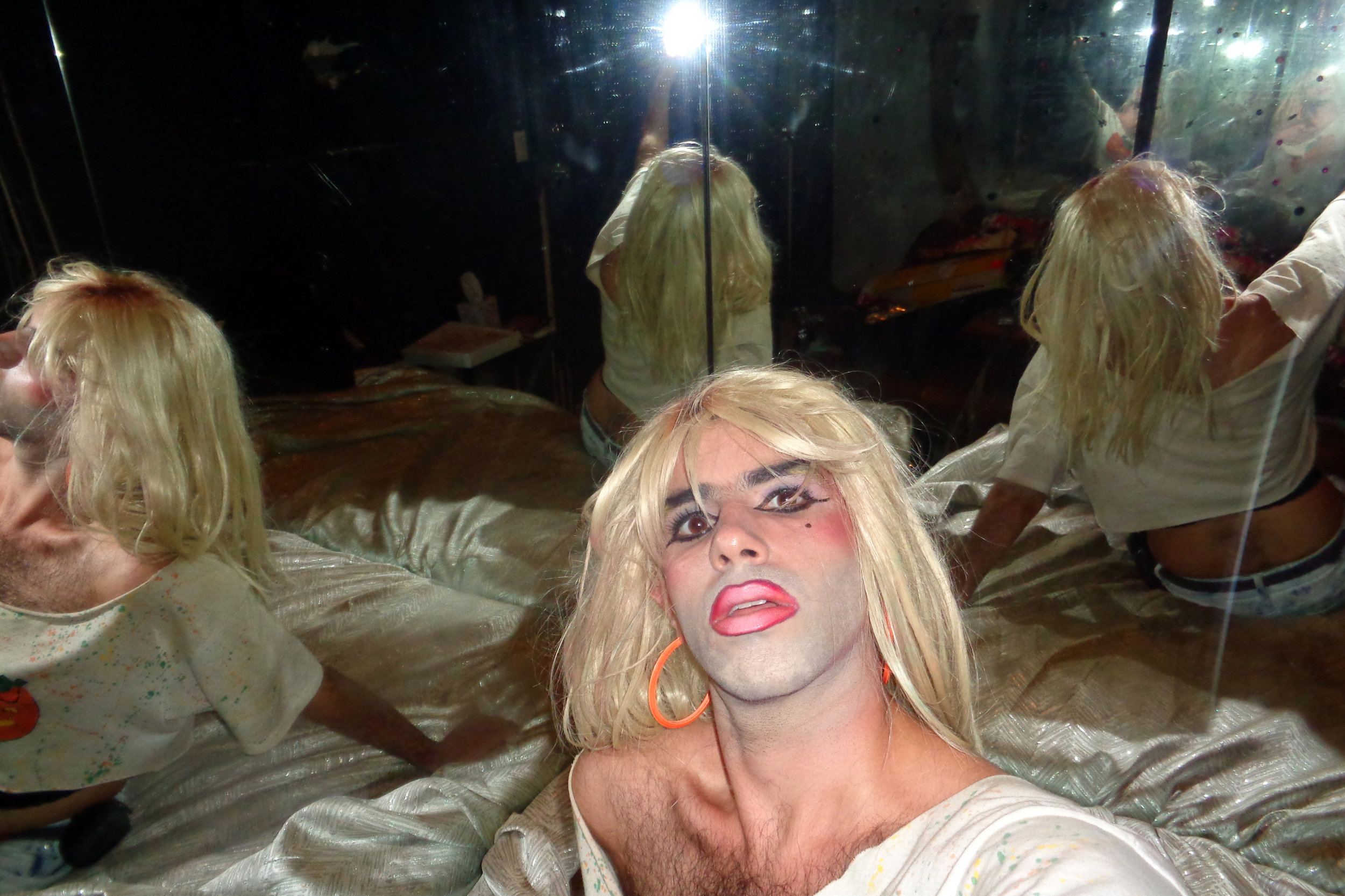 A selfie taken backstage at the former venue, The Spectrum. "I like the depiction of fractured selves in the dirty mirror, the glow of the point-and-shoot flash, and my heavy liner/gradient lip look."