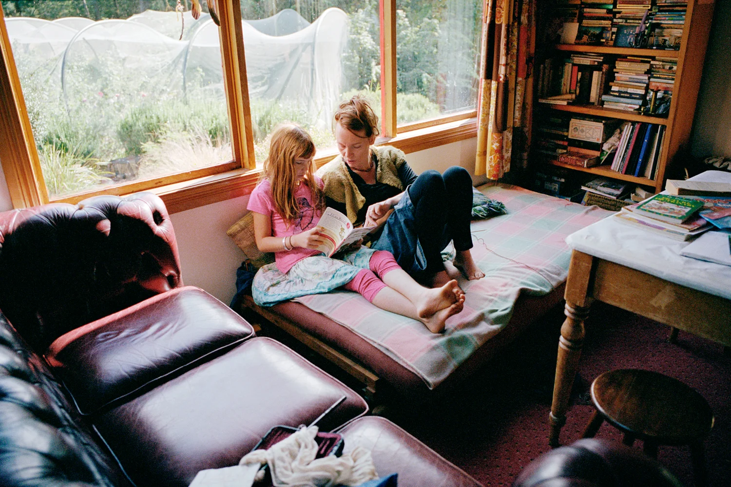 "We read every day; good books are key to our lives. As a parent time is truly dedicated one-on-one. You have a good understanding of where they are emotionally and what has been happening developmentally. There is a continuum of engagement that enables you to have insights that a teacher wouldn't have." Tara and Will Ulbrich reading together at home. Reedy Marsh, Tasmania.