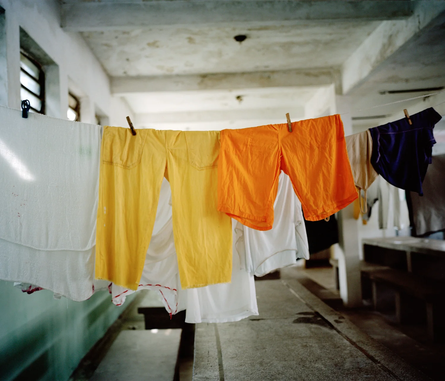 Two pairs of yellow pants and two white T-shirts are the only clothes given to new arrivals at the prison. Pyjamas, underwear and shoes have to be bought at an inflated price from Brazilian inmates whose families visit at weekends and import tradable goods. These are affordable only once the new arrival has found work in the prison, which can take around 4 months.