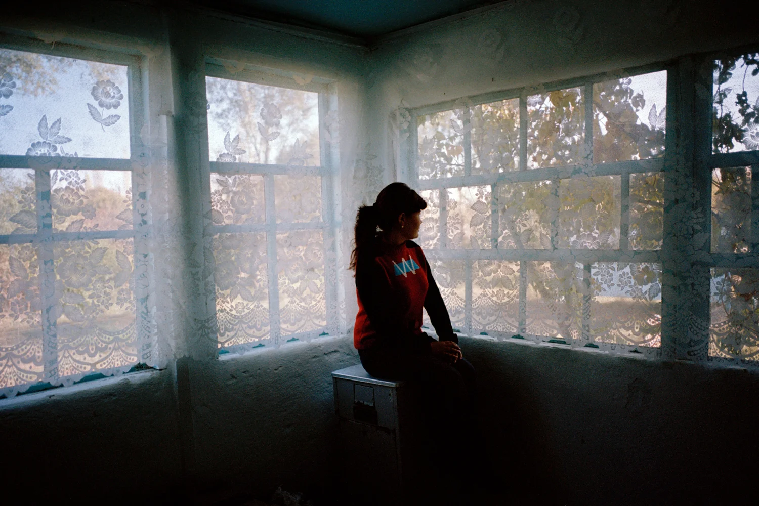 A portrait of a young woman who escaped kidnap and enforced marriage because of the bravery of her aunt who rescued her from her kidnappers, a powerful family with police affiliations. She dropped the case against them after receiving threatening phone calls and because of the potential scandal it would create for her family. Having spent the night in a kidnapper’s house, her virginity would be in question and her family’s reputation ruined, along with her future marriage prospects. Kidnapped brides and their families rarely prosecute because corruption is rife in the justice system and the police are commonly paid off by the kidnapper and his family. Issk-Kul Oblast, Kyrgyzstan.