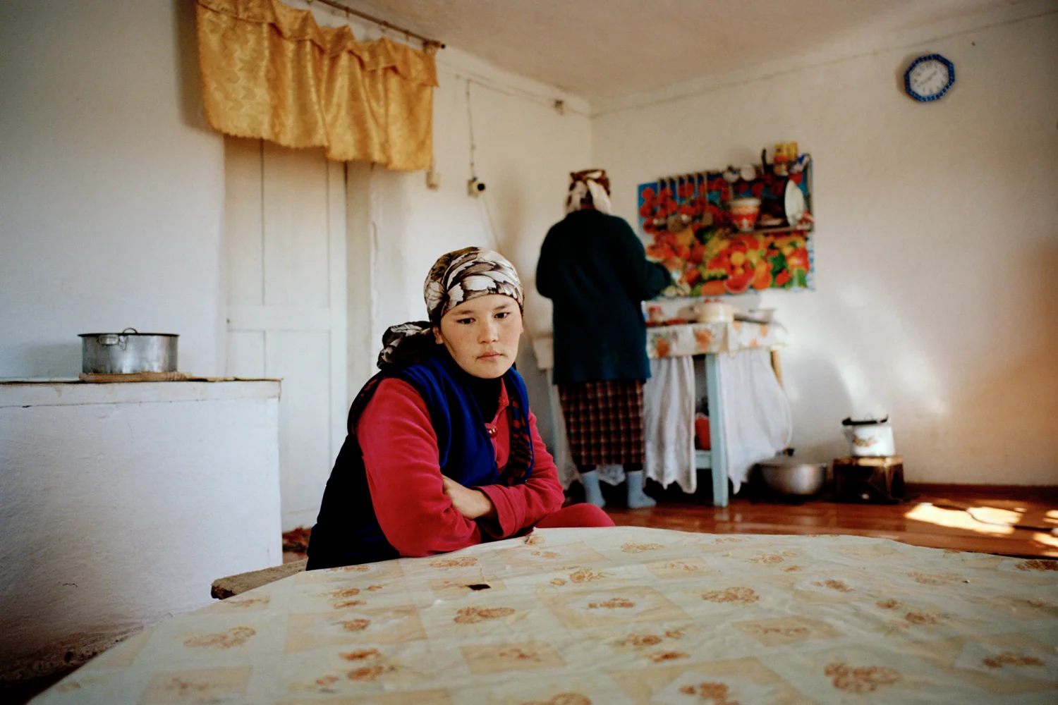 Sophia in a kitchen with her new mother-in-law. Sophia was kidnapped once before and escaped but was forced to stay after the second attempt. As the newest daughter-in-law she takes on the lowest position in the family and must do all the domestic chores. Issyk-Kul Oblast, Kyrgyzstan.