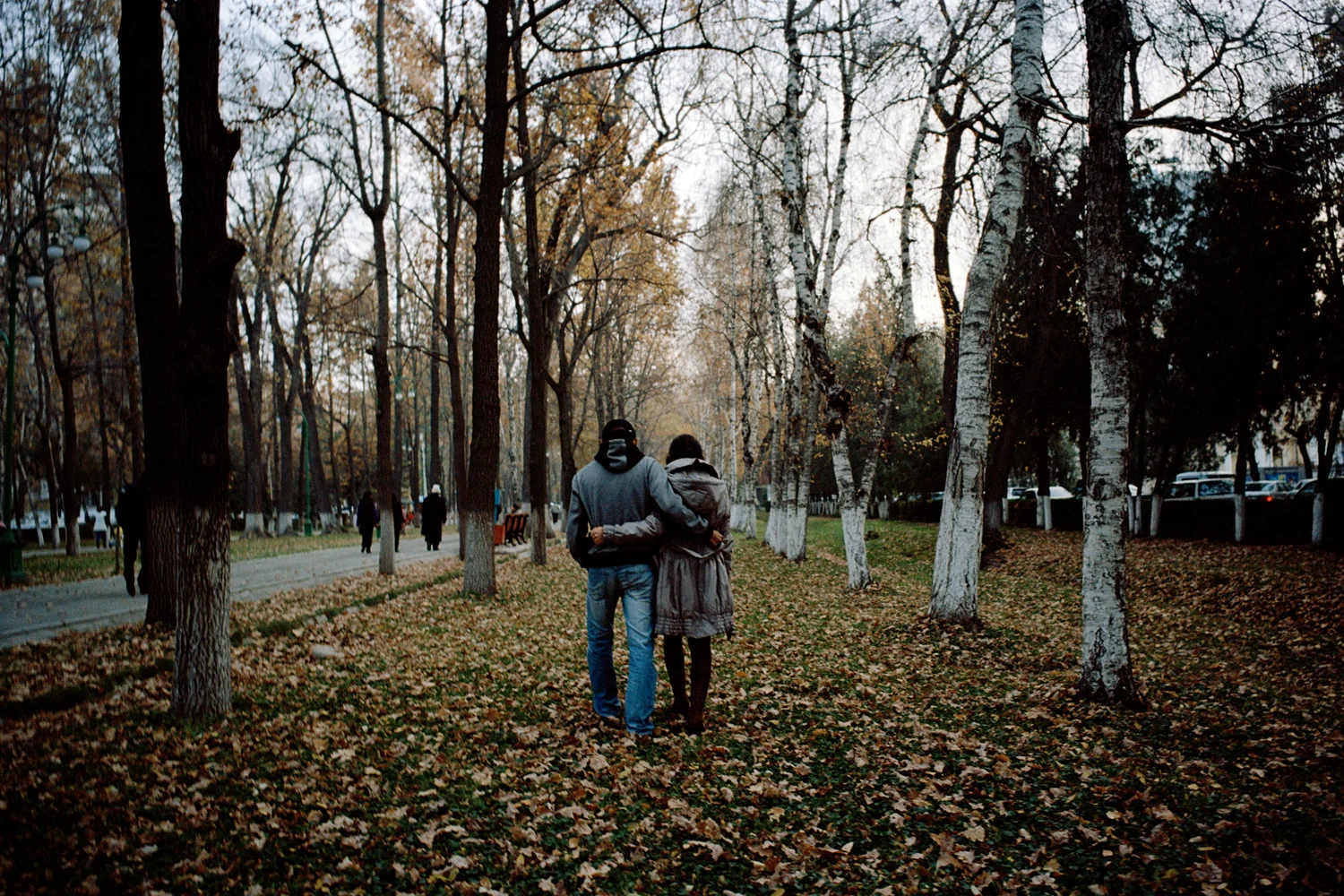 A married couple walk in a park in Bishkek. Whilst both living and working in neighbouring Kazakhstan she was kidnapped for marriage by a Kazakh man. Although she eventually escaped back to Kyrgyzstan with her current husband, the couple maintain their anonymity to protect his family. In Muslim Kyrgyzstan, where virginity is revered, a girl who has been kidnapped and then leaves is considered to be tainted. Bishkek, Kyrgyzstan.