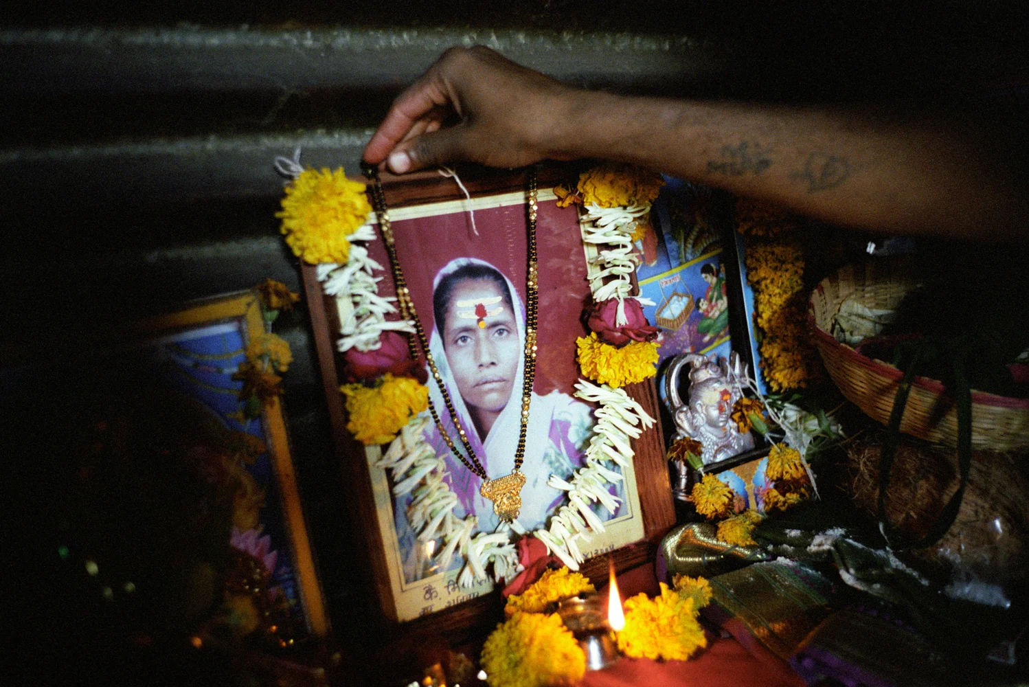 Pandu's alter where he keeps a picture of his mother, a sex worker. After loosing her other 10 children, Pandu’s mother prayed to Yellamma promising to dedicate him as a Jogappa if the goddess kept him alive