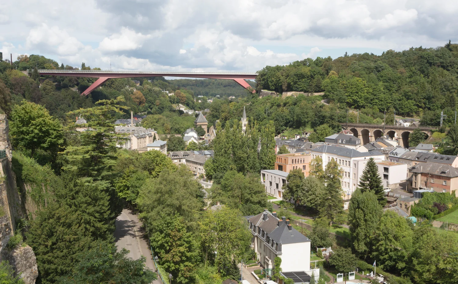 The Pfaffenthal project is a model of urban density in a historical context. In a confined space an administrative building for ecological consulting agencies, a school and social housing have been inserted. Accordingly tight is the programming of the open space. The central school yard offers plenty of space for free movement, the Bistrot of the Oeko - Zenter gets a terrace framed by vegetation. The public paths connect to the neighbourhood and integrate into the fabric of the Pfaffenthal.