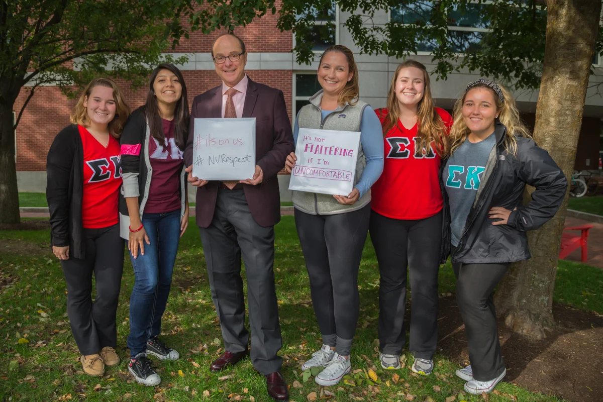Northeastern's President Aoun joins students at the block party standing up against street harassment. October 2014. 