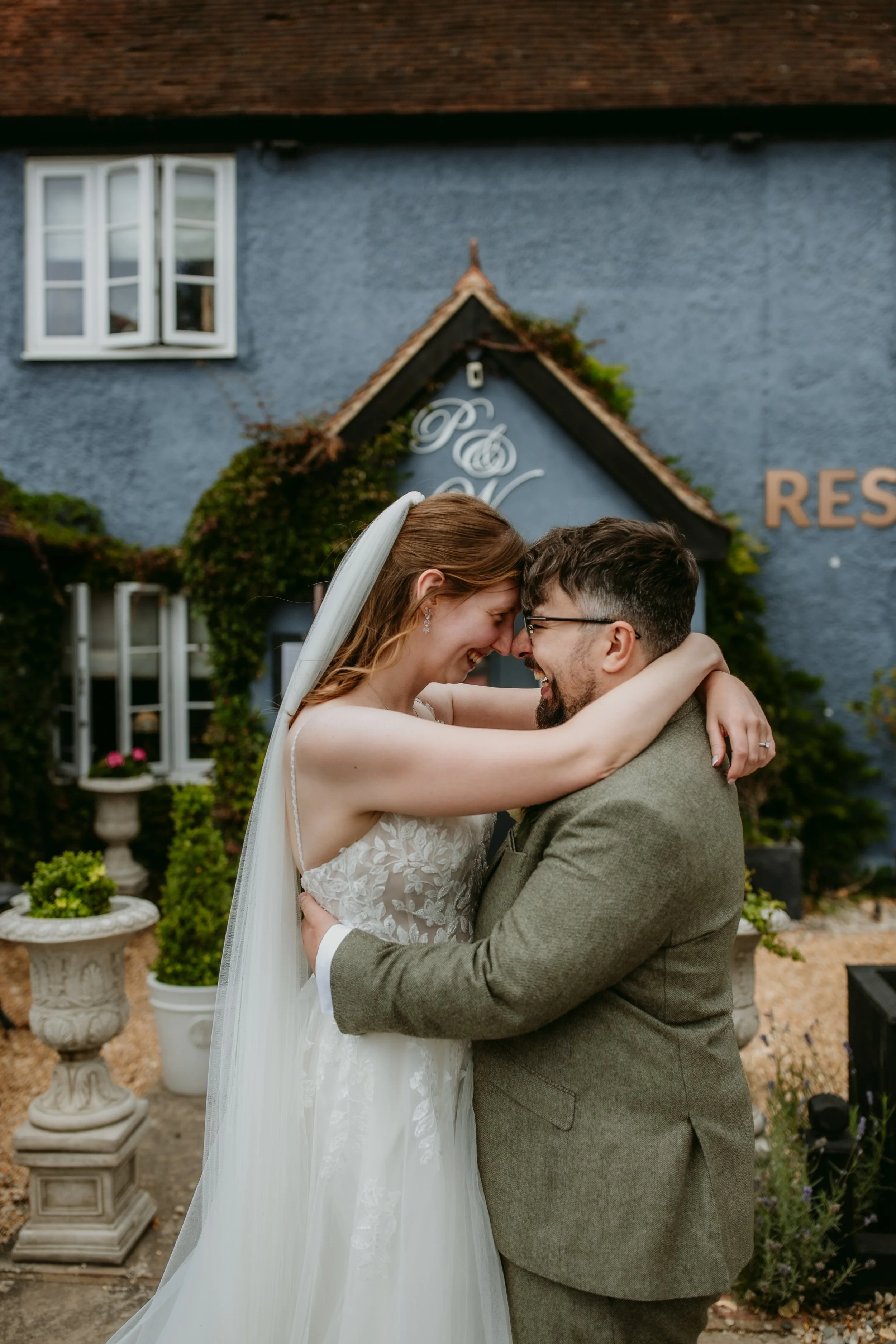 Bride and Groom kissing outside the Pig & Whistle Restaurant