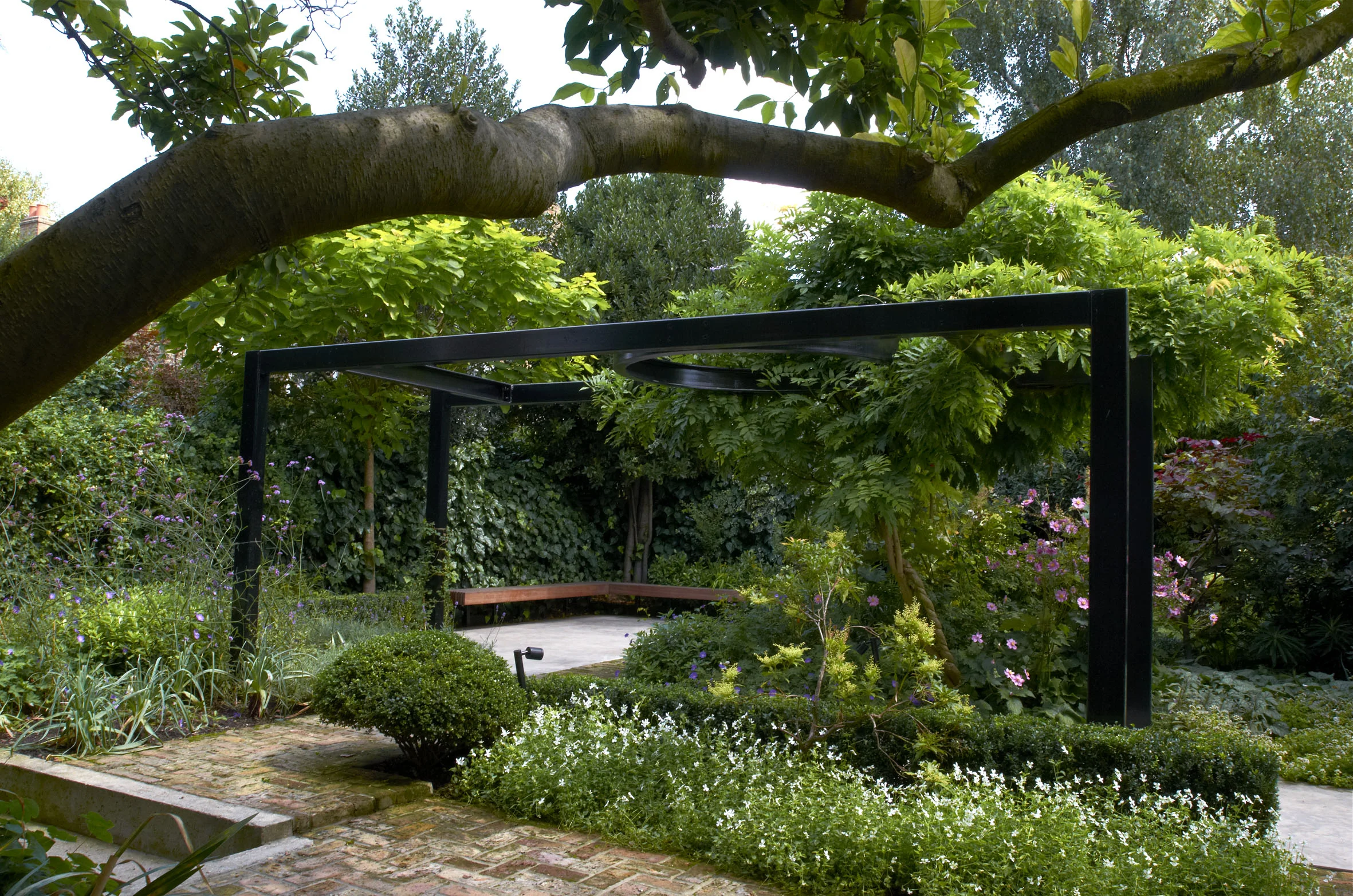 new steel pergola + hardwood cantilver benches