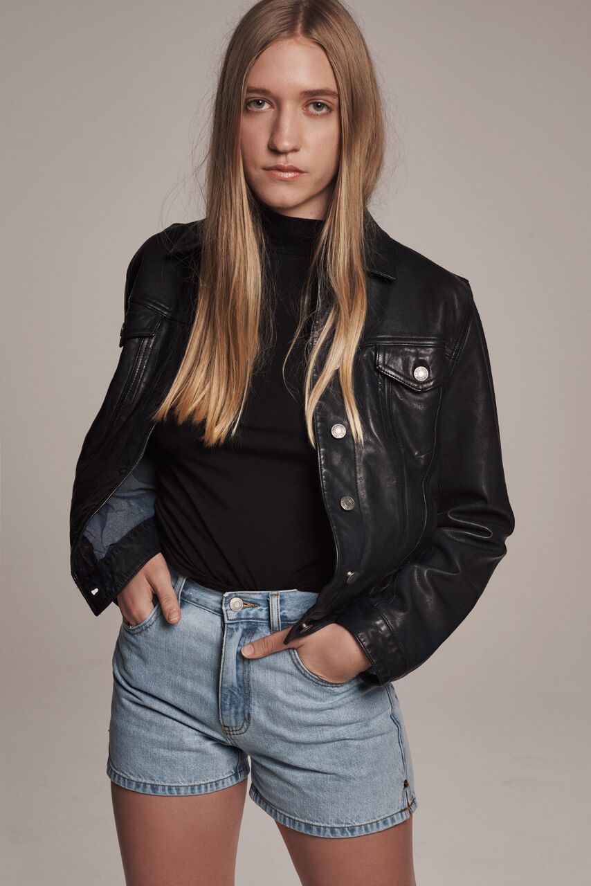  Artist Coco Gordon, daughter of Kim Gordon who wore the Pocket Tee in her 1990 ad, wears the navy Icon Leather Jacket, black short-sleeve Mockneck Tee and High Rise Denim Short in the film. -&nbsp;“My mom always bought me Gap clothes... we definitel