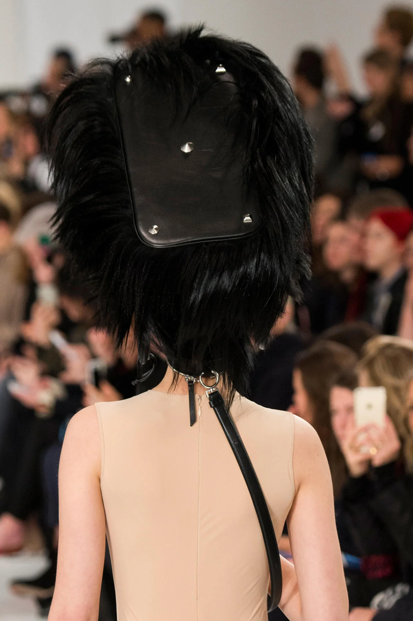 MAISON MARGIELA'S FALL RUNWAY FEATURED FEATHERS AS MAKEUP AND HANDBAGS AS HAIR ACCESSORIES