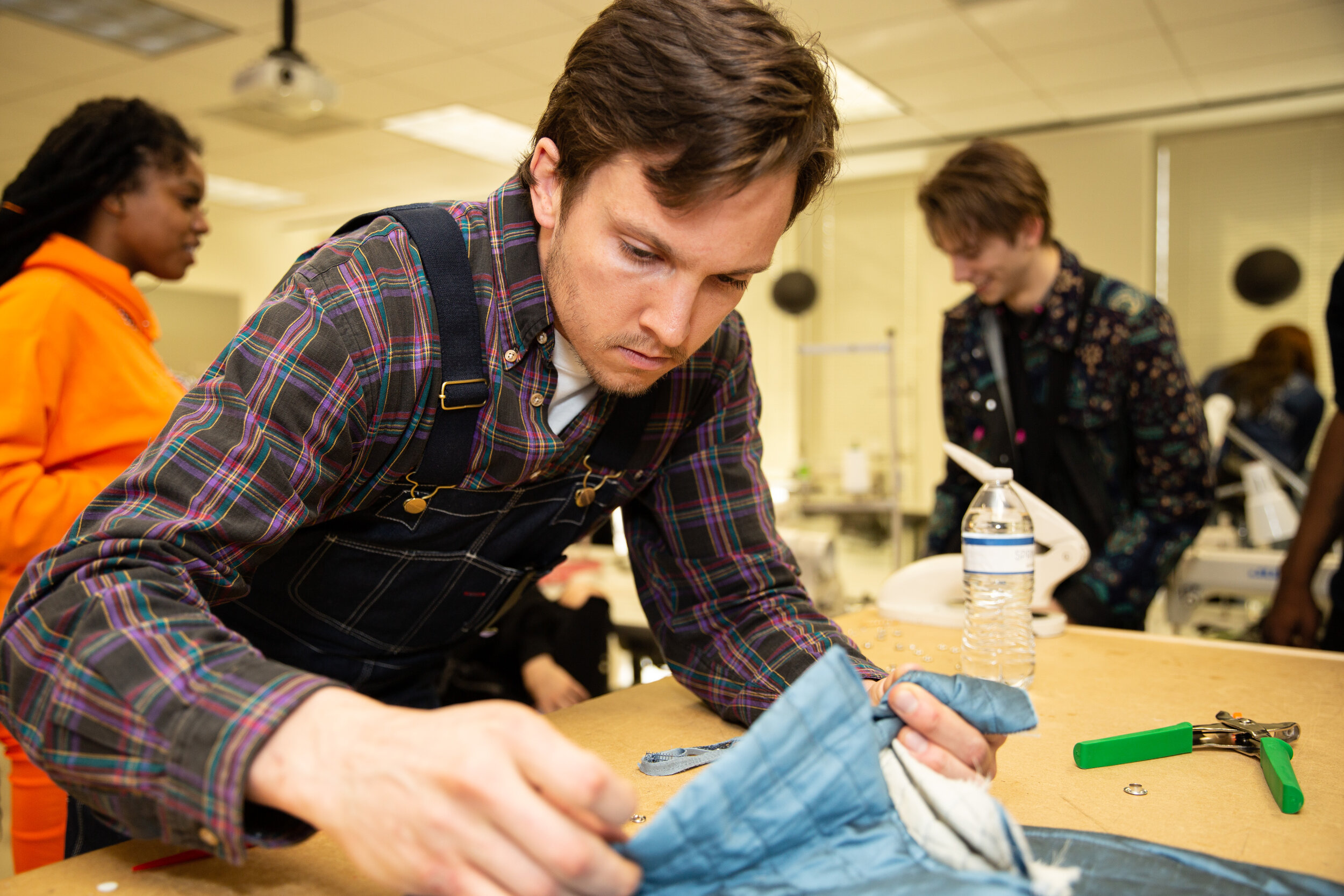 Art Institute of Atlanta designers in sewing studio pre-show.