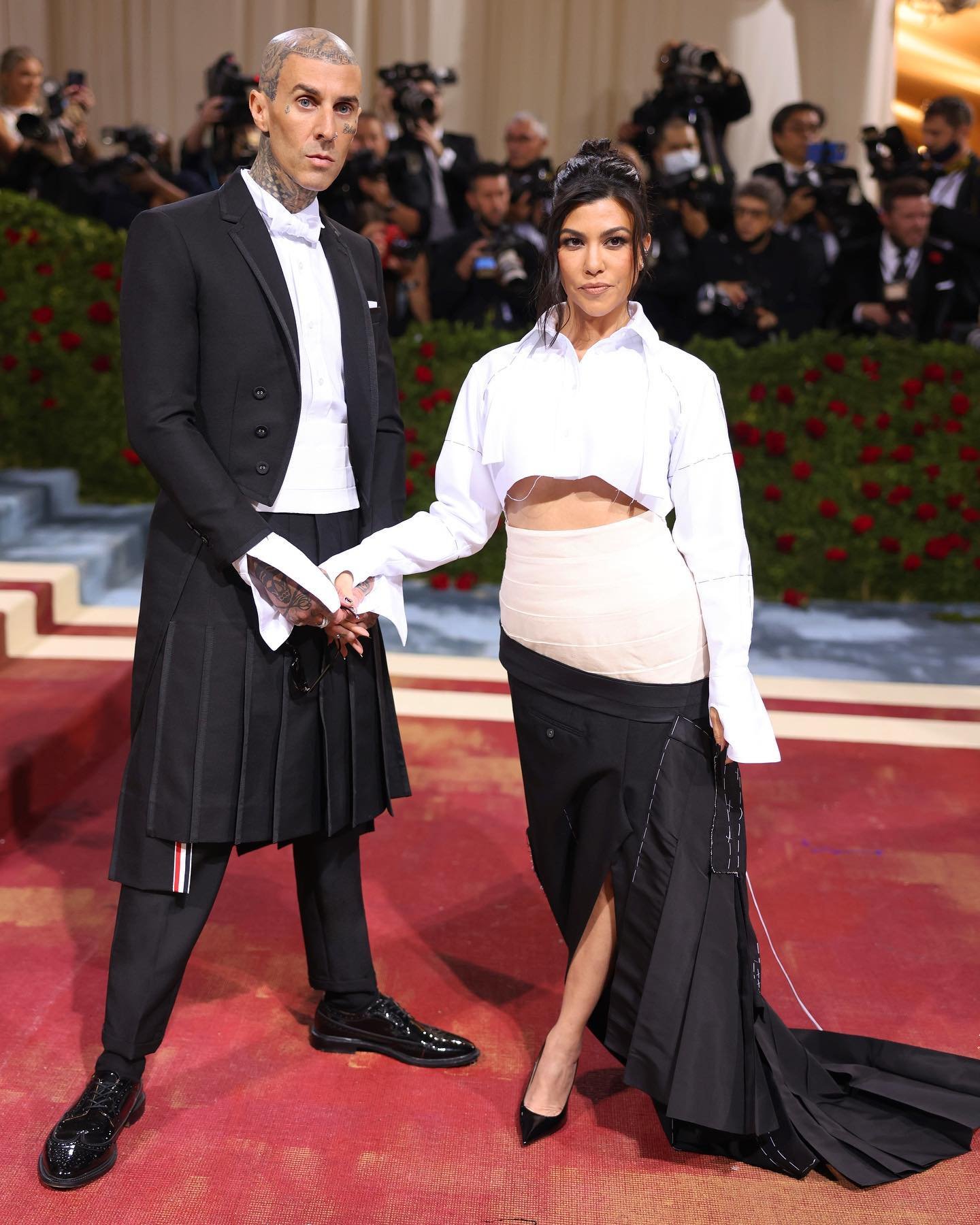  Travis Barker wears a high armhole tailcoat in 2-ply mohair &amp; Kourtney Kardashian wears a deconstructed interpretation of Travis’ look.