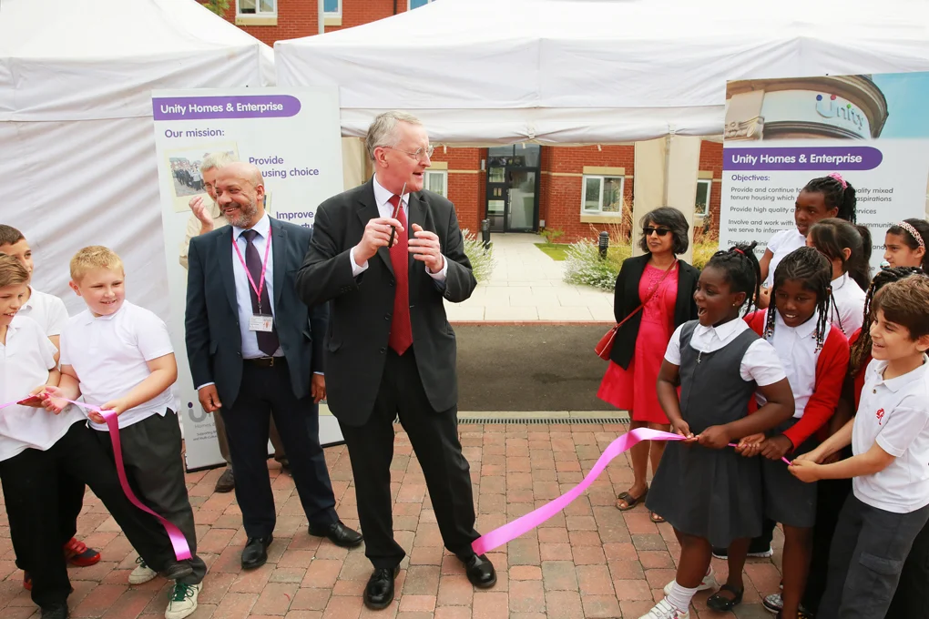 Leeds Central MP Hilary Benn (centre) cuts the ribbon at the new Brown Lane East affordable housing development in Holbeck. Watching on are Unity chief executive Ali Akbor (left), Unity chair Shruti Bhargava (right) and pupils from Ingram Road Primary School