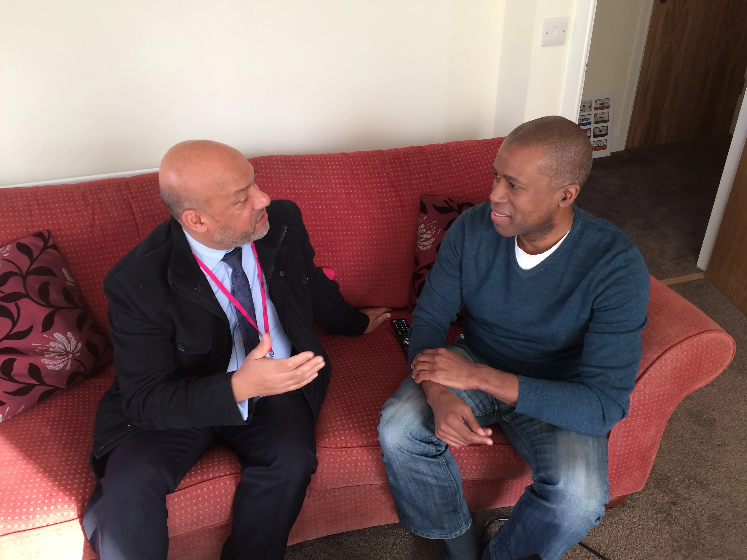 Holborn Court tenant Ian Bailey (right) chats to Unity chief executive Ali Akbor in the living room of his new property in Little London