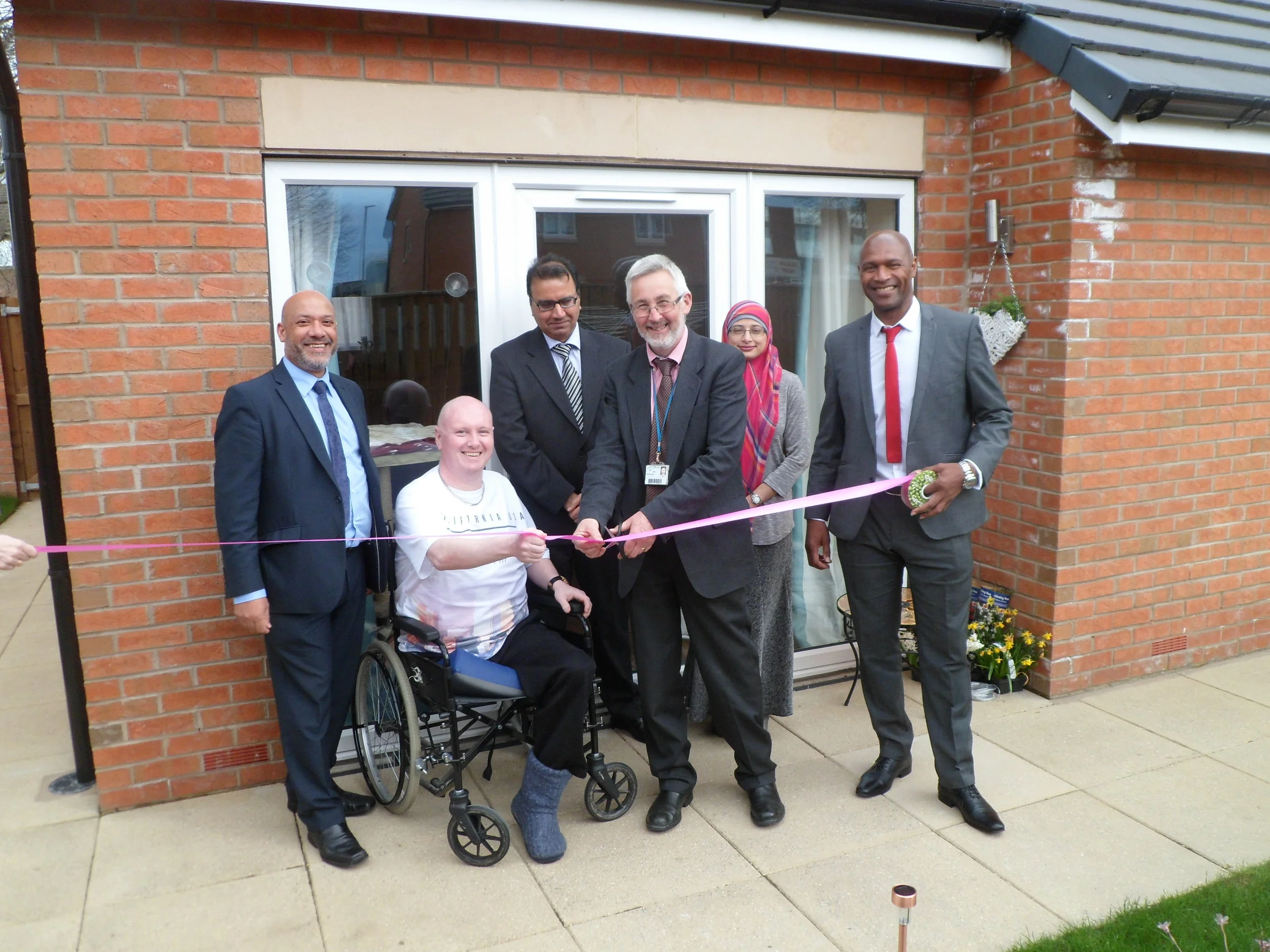 Cllr Richard Lewis cuts the ribbon to officially open Rocheford Court, assisted (from left to right) by Unity chief executive Ali Akbor, resident Jonathan Griffiths, Unity board members Naseer Ahmed and Shazia Khan, and Unity regeneration director Wayne Noteman