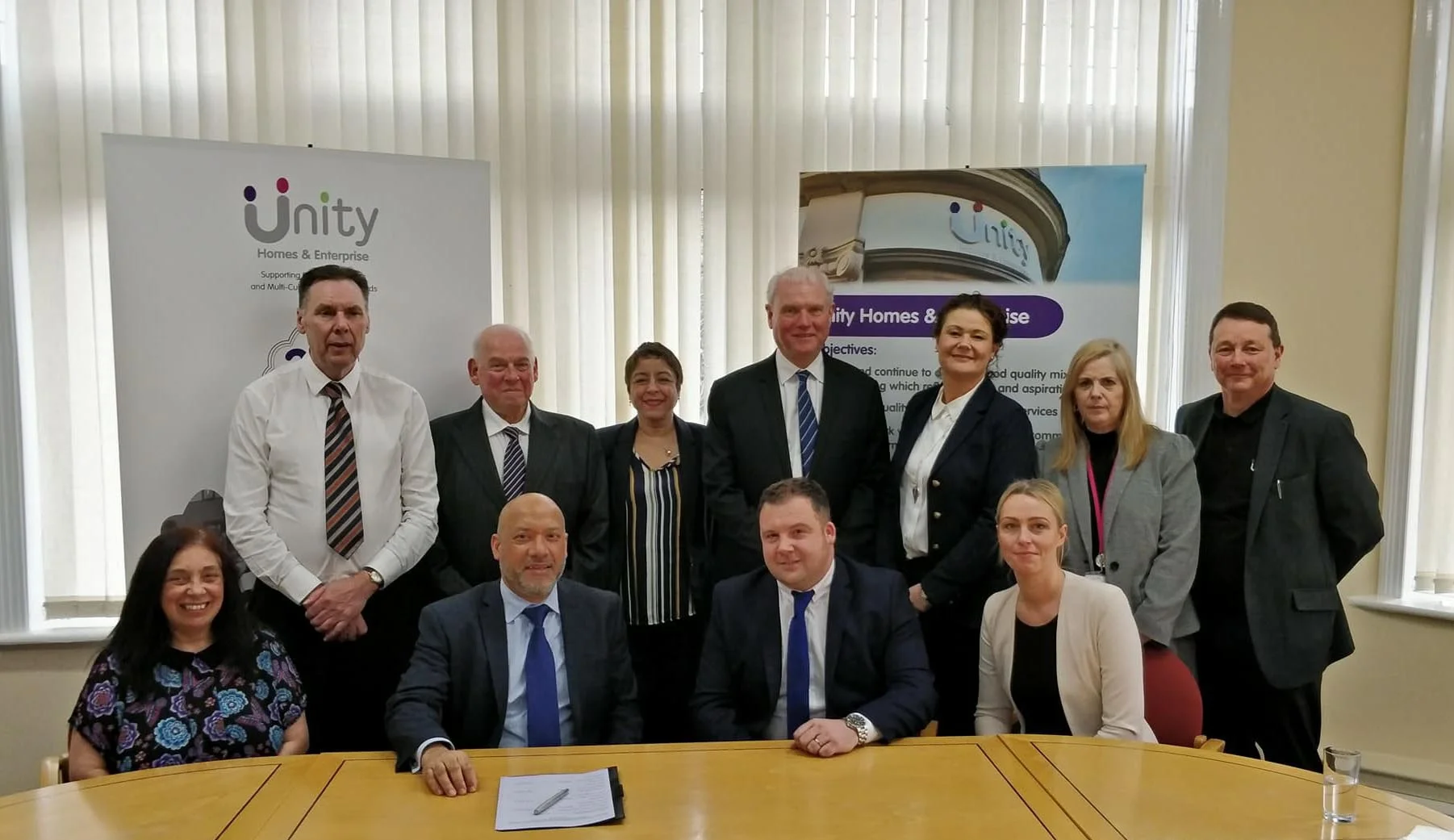 Ali Akbor (front, second from left) and Gary Thewlis (front, second from right) with staff from Unity Homes and Enterprise and GTD Painting and Property Maintenance. Also included are Unity tenant Belinda Letham (front, left) who assisted with the procurement process alongside Adrian Smith (back row, second from left) and Nigel Barr (back row, fourth from right) from consultants Stradia 