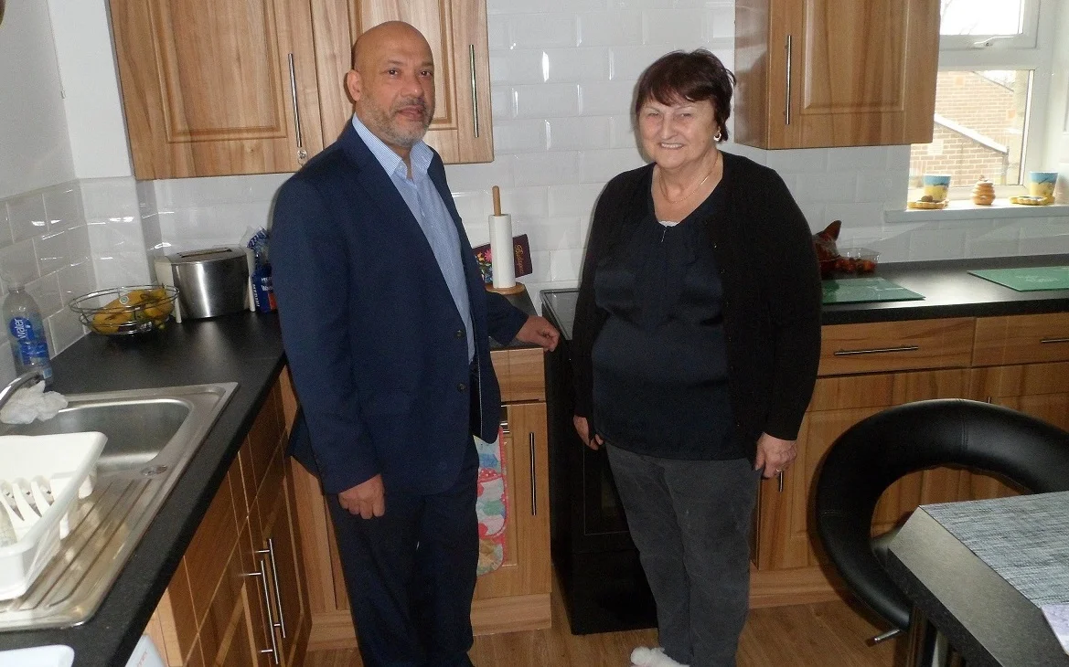 Mrs Mortimer, a Chapel Fold tenant, in her brand-new kitchen with Unity Chief Executive Ali Akbor