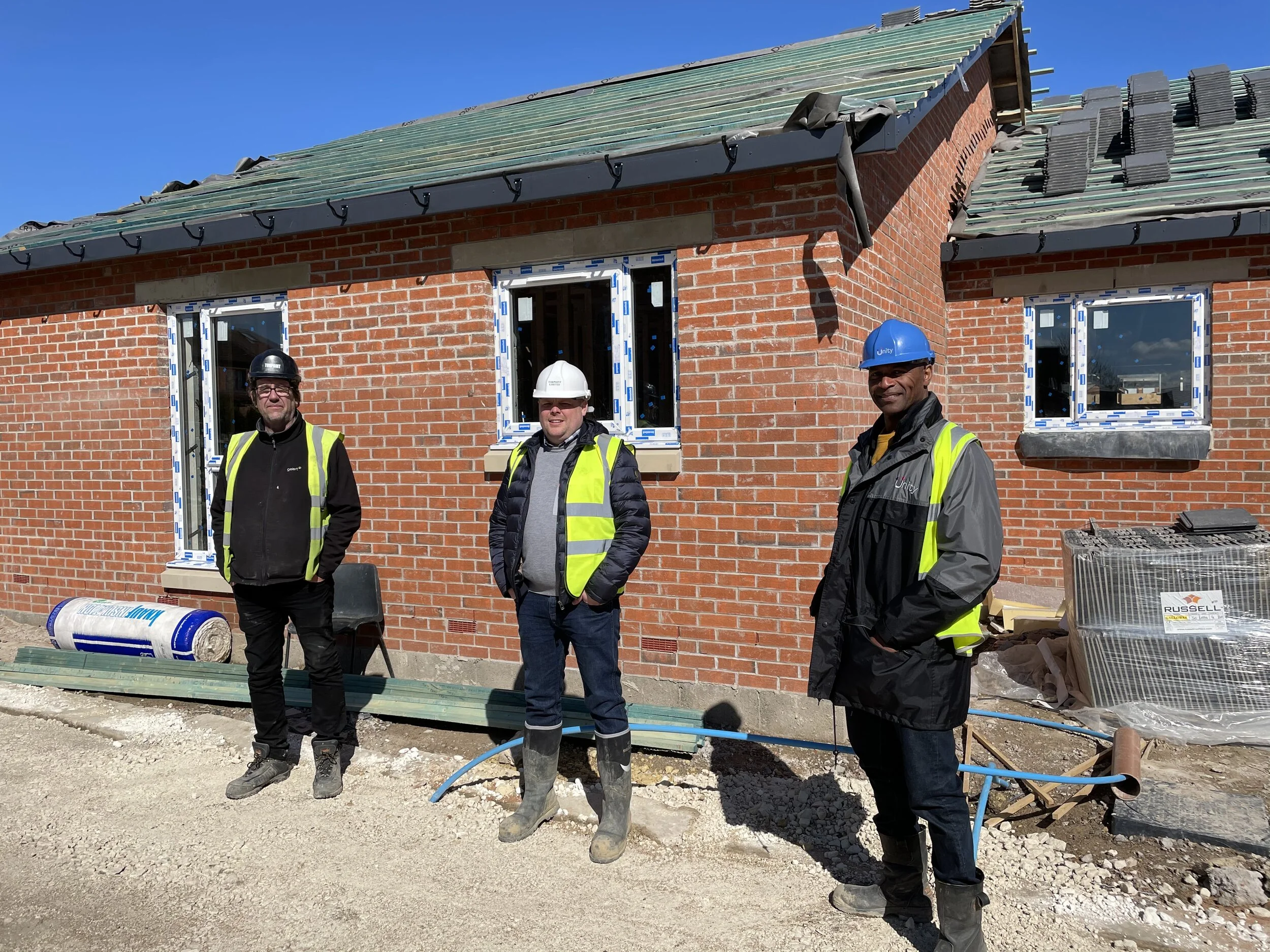 Wayne Noteman, Unity Regeneration Director (right) with Josh Paterson, Torpoint Director (centre) and Mick Rogers, Torpoint Site Manager (left), outside one of the new Dale Lane properties which is nearing completion