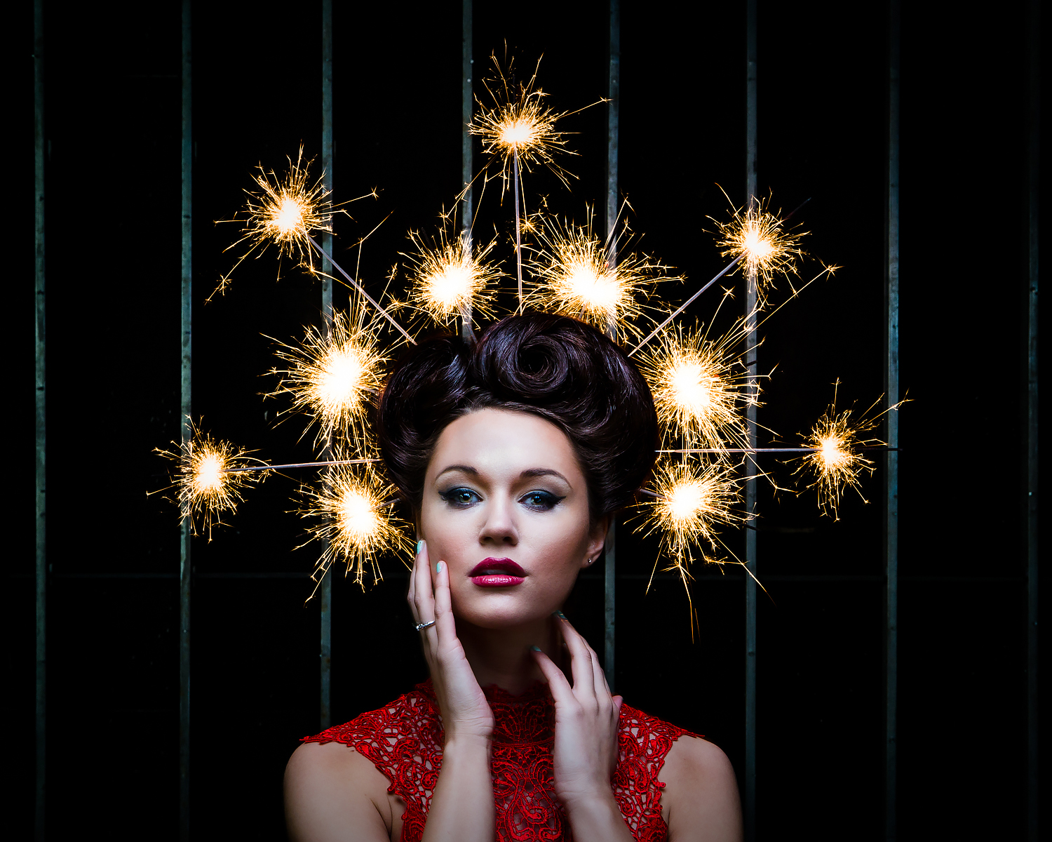 Fashion portrait with sparklers burning in models hair