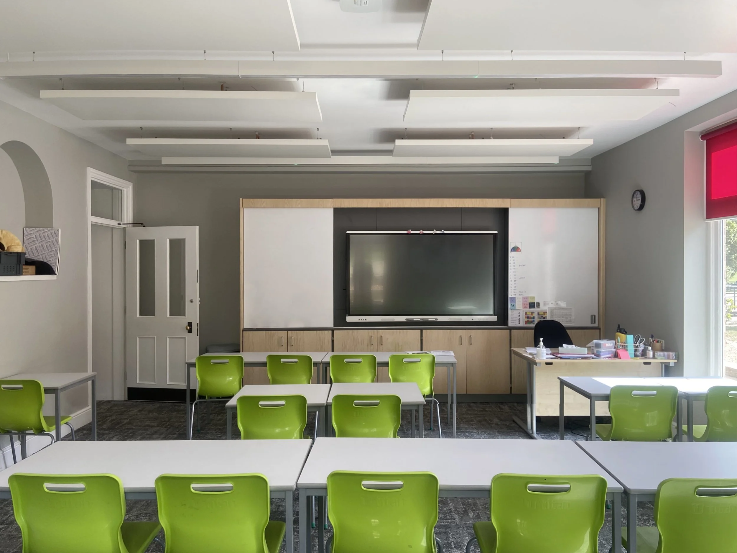 classroom fitted with teachers’ wall; combining large format screen, board, storage and projector by Fletcher Crane Architects