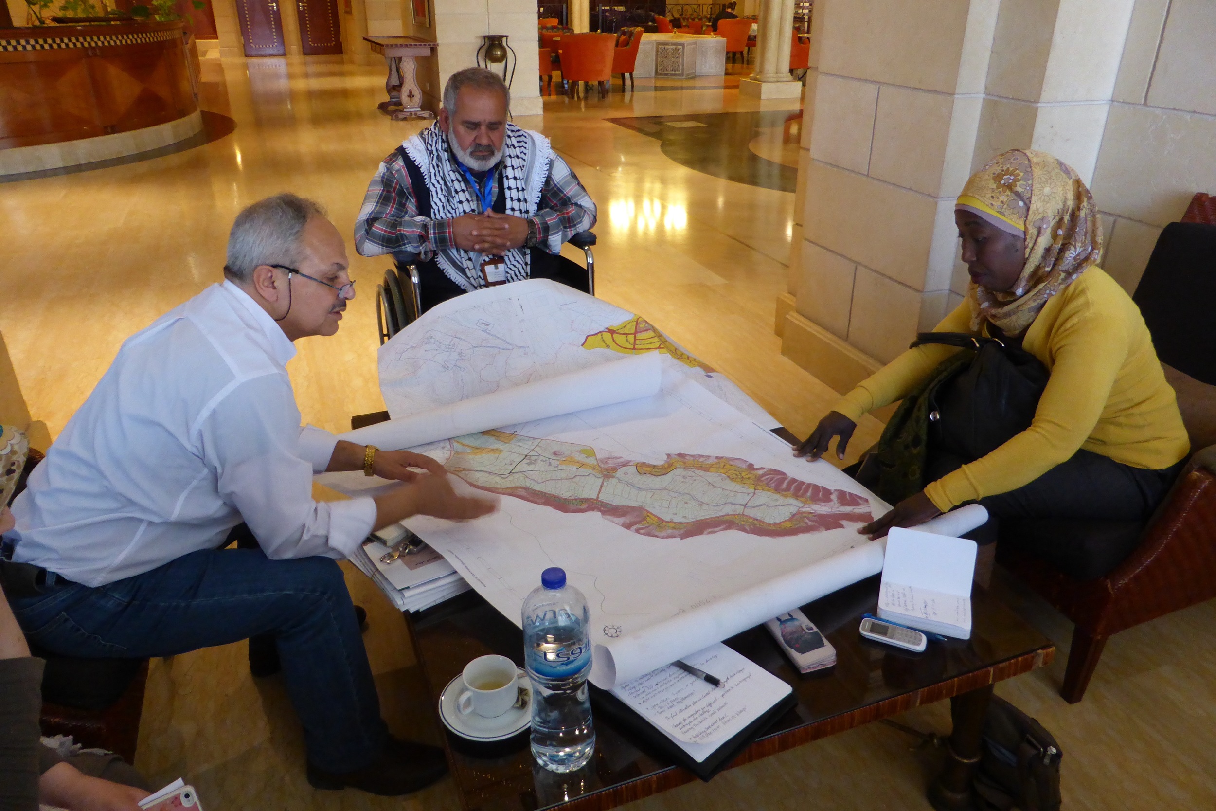 Haj Sami Sadeq, mayor of Al Aqaba, and a village council member from another village, meet with Dr. Rassem Khamaisi, professor at Haifa university and planner with the International Peace and Cooperation Center. 