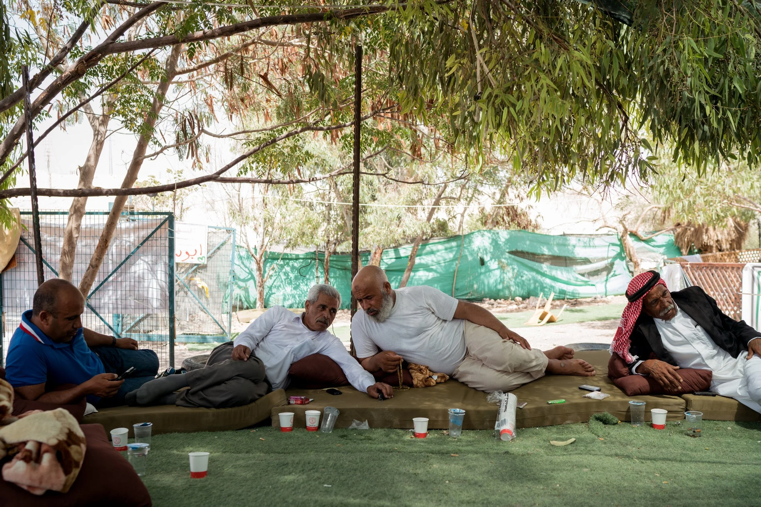 Palestinian Bedouin men sit together in Khan al-Ahmar on July 26, 2018. Photo: Samar Hazboun for The Intercept