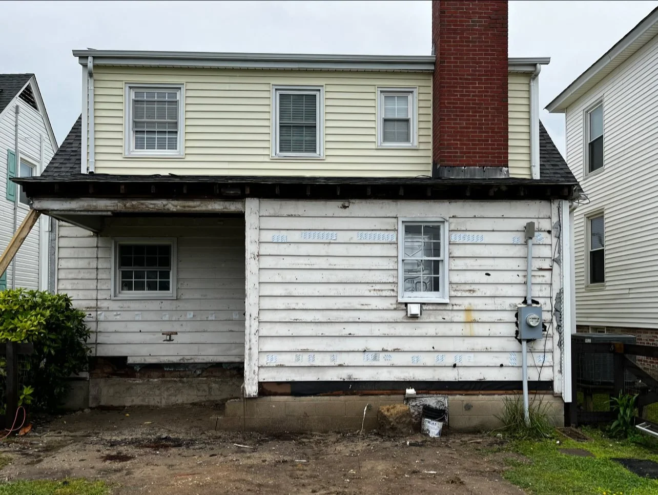 Before photo of a two-story house in the early stages of an addition and renovation in Cape Charles, VA.