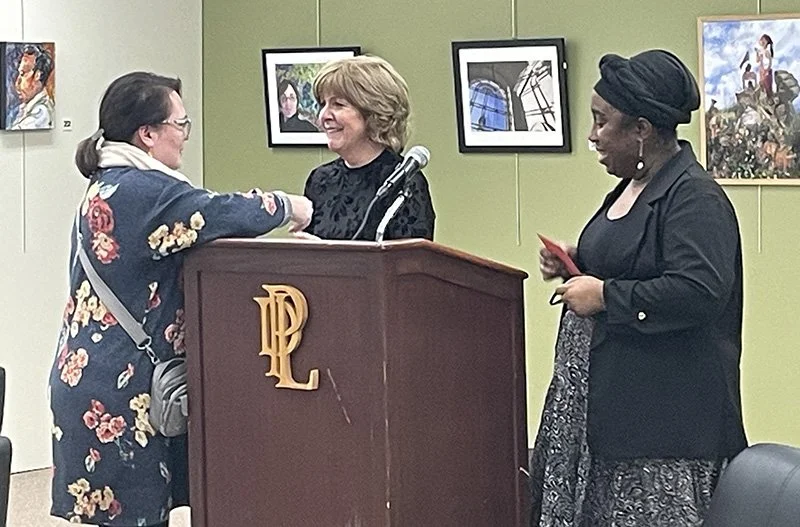 First-Place winner Michele Hunt receiving her award from Exhibitions Chair Margaret Reese and Juror Takeisha Jefferson
