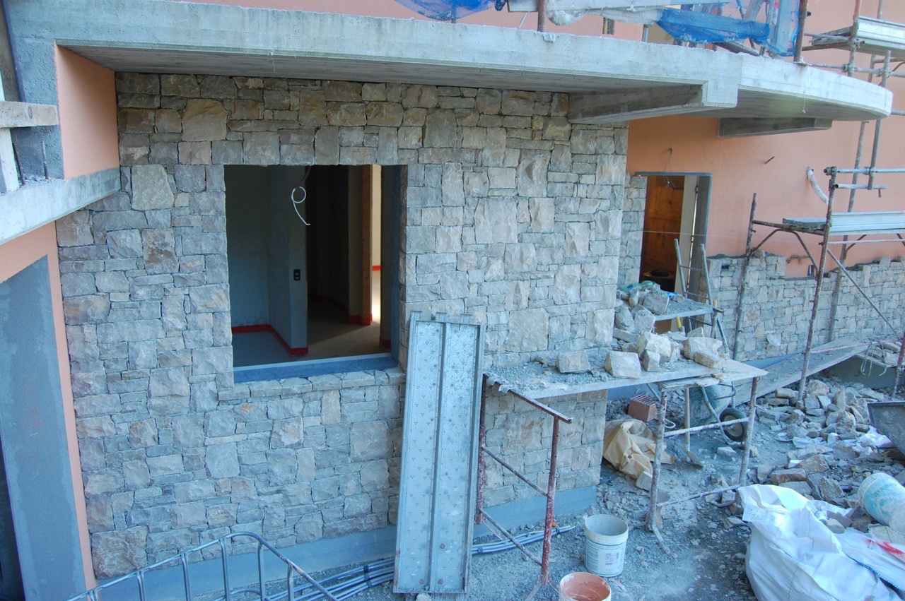 Exterior stone is being applied to the first level.